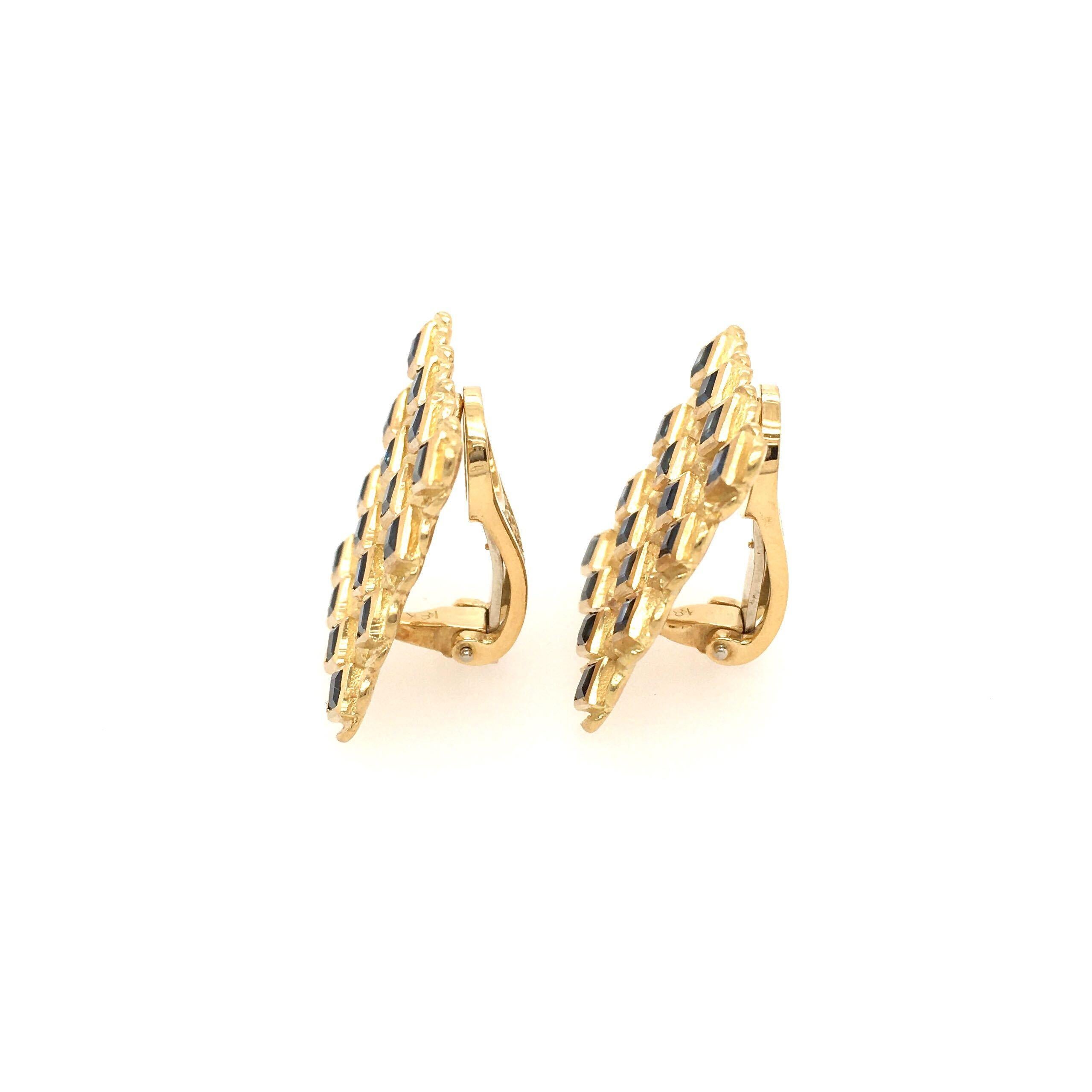 A pair of 18 karat yellow gold and sapphire earclips, Janet Yaseen.  Designed as openwork squares, each set with sixteen (16) sapphires measuring approximately 2.90 mm.  Width approximately 7/8 inch.  Gross weight approximately 17.70 grams.  With