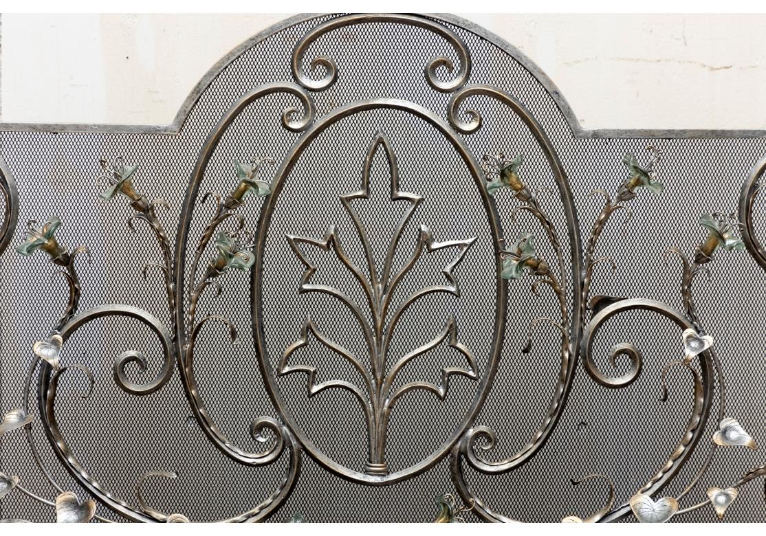 A solid and heavy pewter color fireplace screen decorated with scrolls and leaves and enchanted by glass amaryllis flowers. The screen rests on trestle base feet and bears the old hangtag.
Dimensions: 34