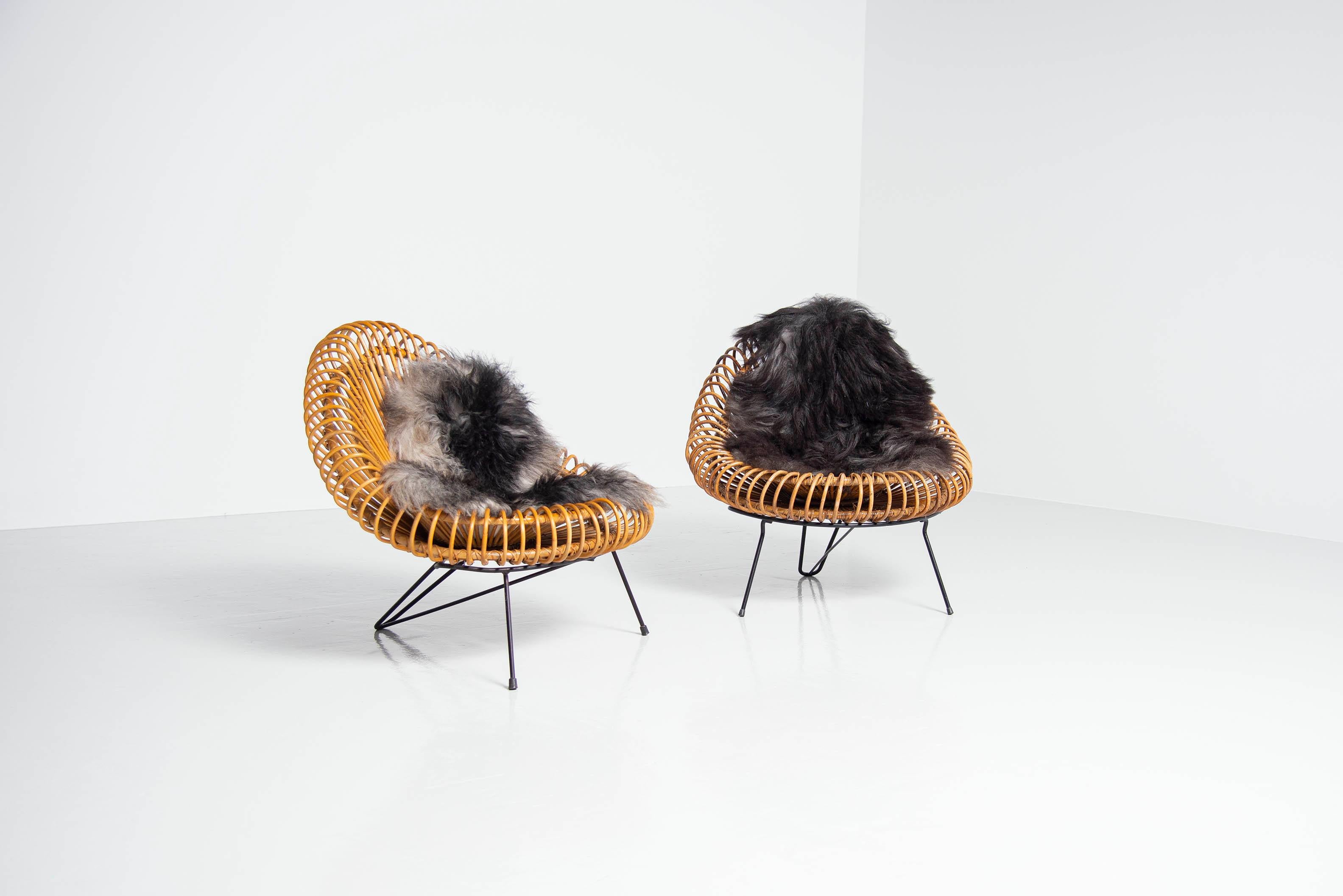 Very cool set of basketware lounge chairs designed by Janine Abraham and Dirk Jan Rol, manufactured by Rougier, France 1950. The chairs have a very nice dynamic shaped metal frame, black painted. And have a rattan seat, beautifully shaped and