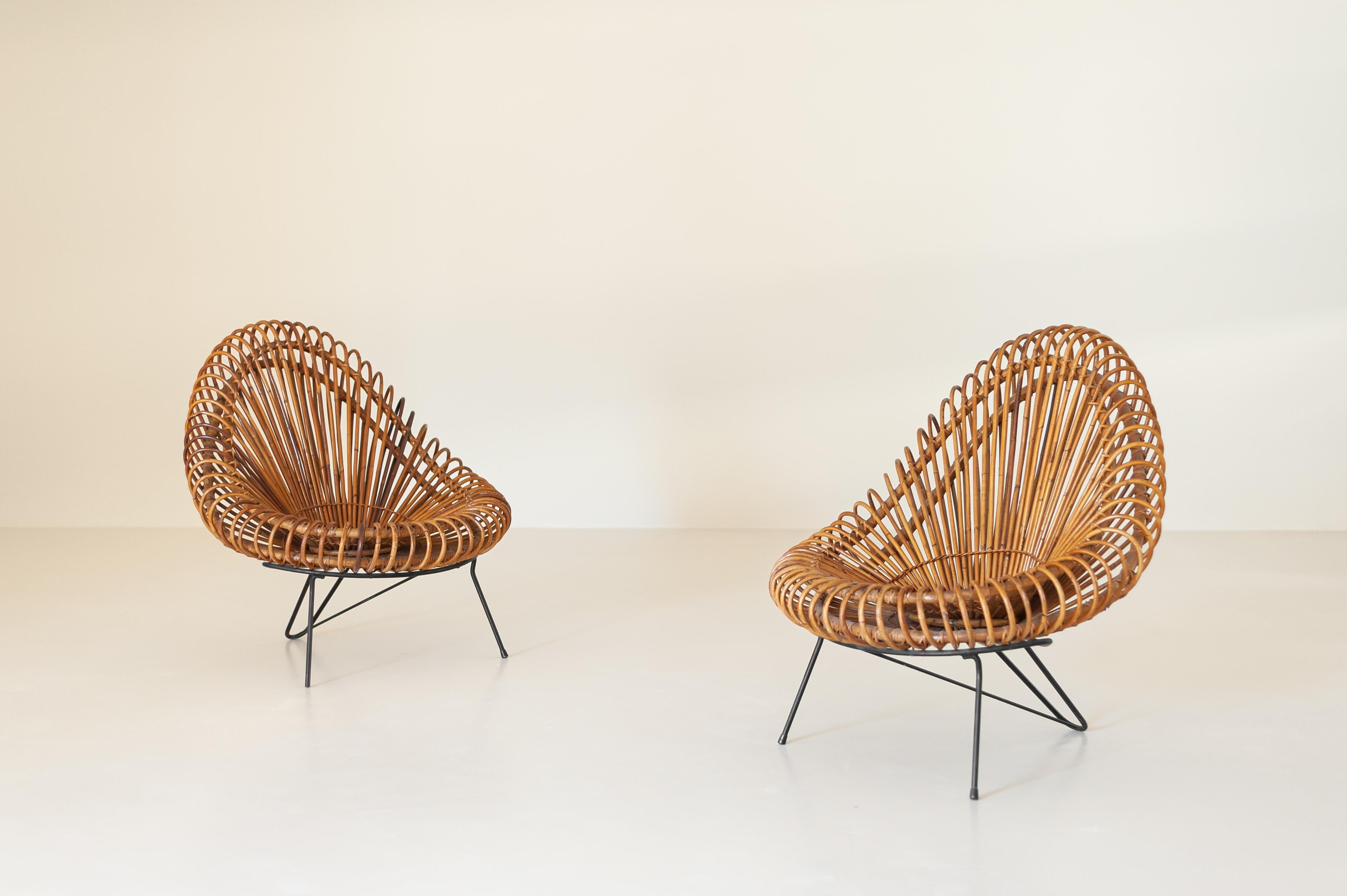 A pair of charming lounge chairs designed by Janine Abraham & Dirk Jan Rol and produced by Edition Rougier in the 1955.
The main characteristic of this model is its sculptural handmade natural basket seat which form an appealing shell shape resting