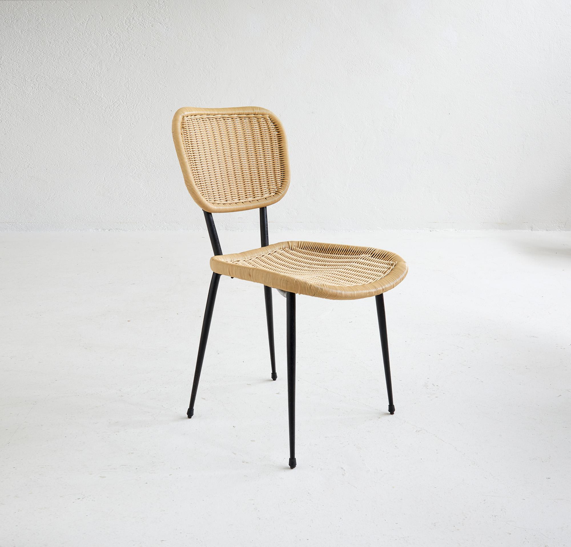 Rare Set of Four Chairs by Janine Abraham for Maison Rougier, France, late 1950s.

This model was presented at the 1956 Salon des Artistes Décorateurs. Each chair features a black lacquered metal base supporting a seat and backrest in rattan,
