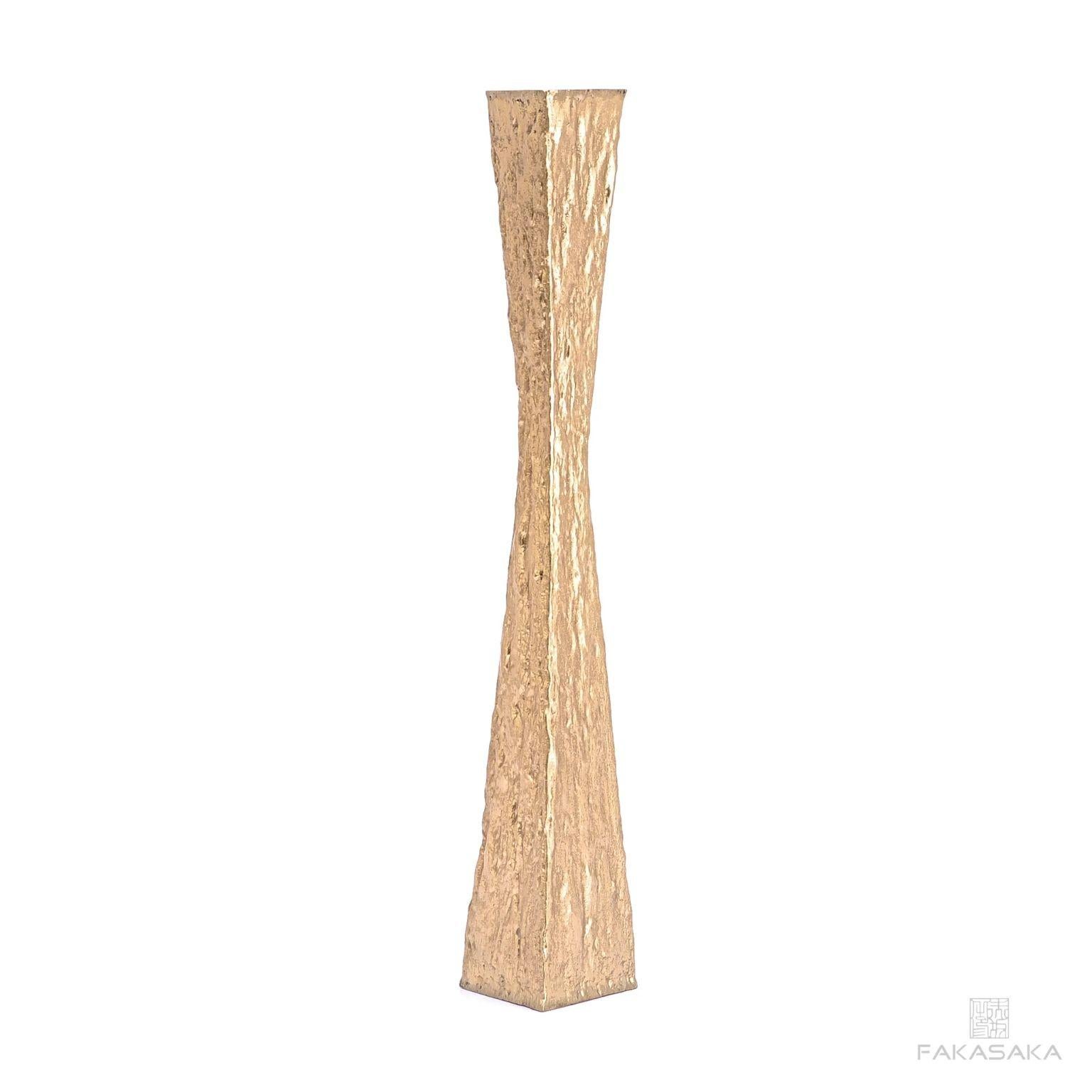 Janis candleholder by Fakasaka design.
Dimensions: W 8 cm D 8 cm H 41 cm.
Materials: polished bronze.

 Fakasaka is a design company focused on production of high-end furniture, lighting, decorative objects, jewels, and