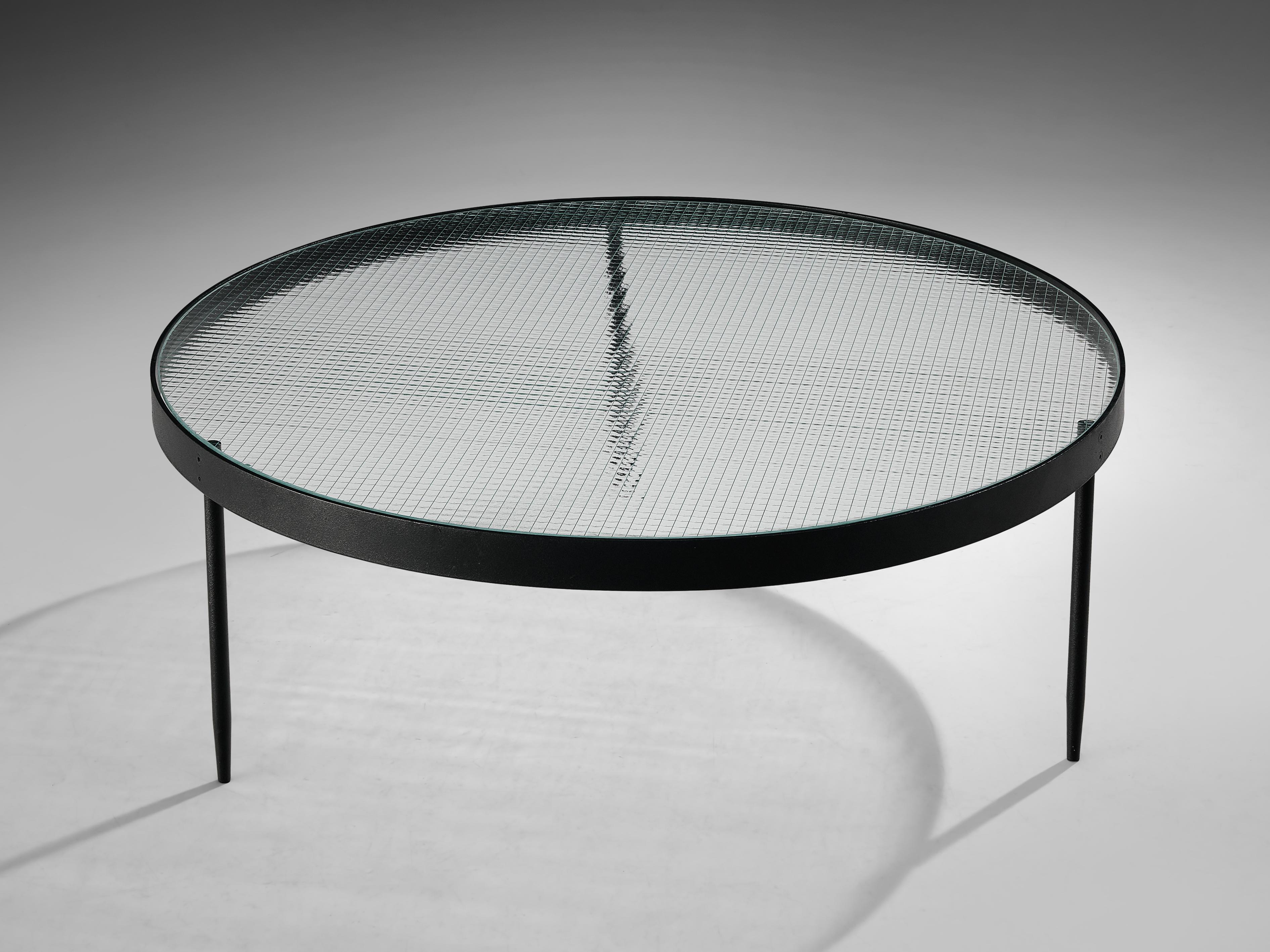 Janni Van Pelt for Bas Van Pelt, coffee table, glass and black metal, the Netherlands, 1950s. 

Round coffee table in black coated metal and glass. This table is the model G4. The base consists of four legs with a cross-connection. The top is made