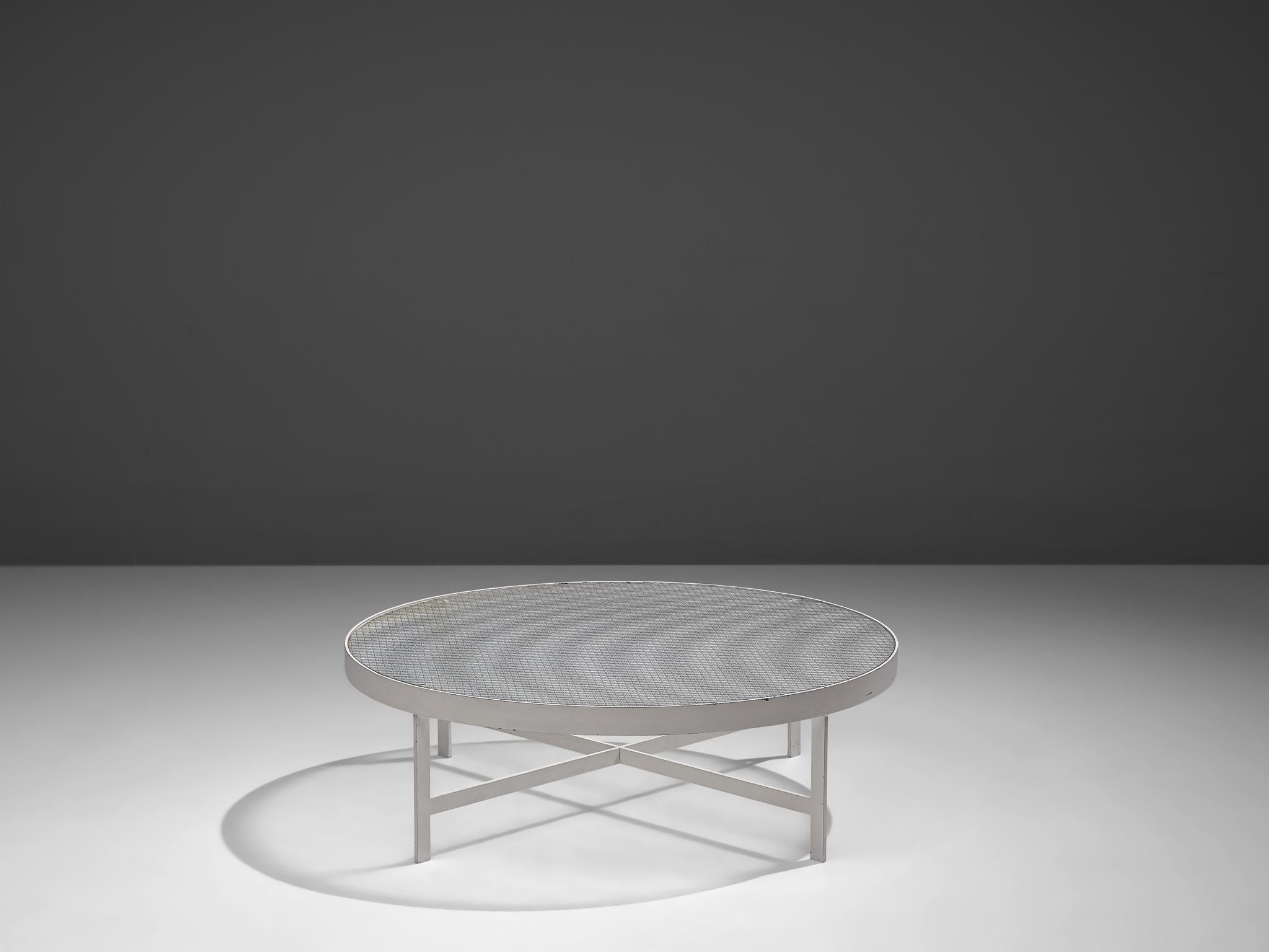 Janni Van Pelt, coffee table, glass and white metal, the Netherlands, circa 1958. 

Circular coffee table in white coated metal and wired glass. This table is a variation on Janni van Pelts model M419. The base consists of four legs with a