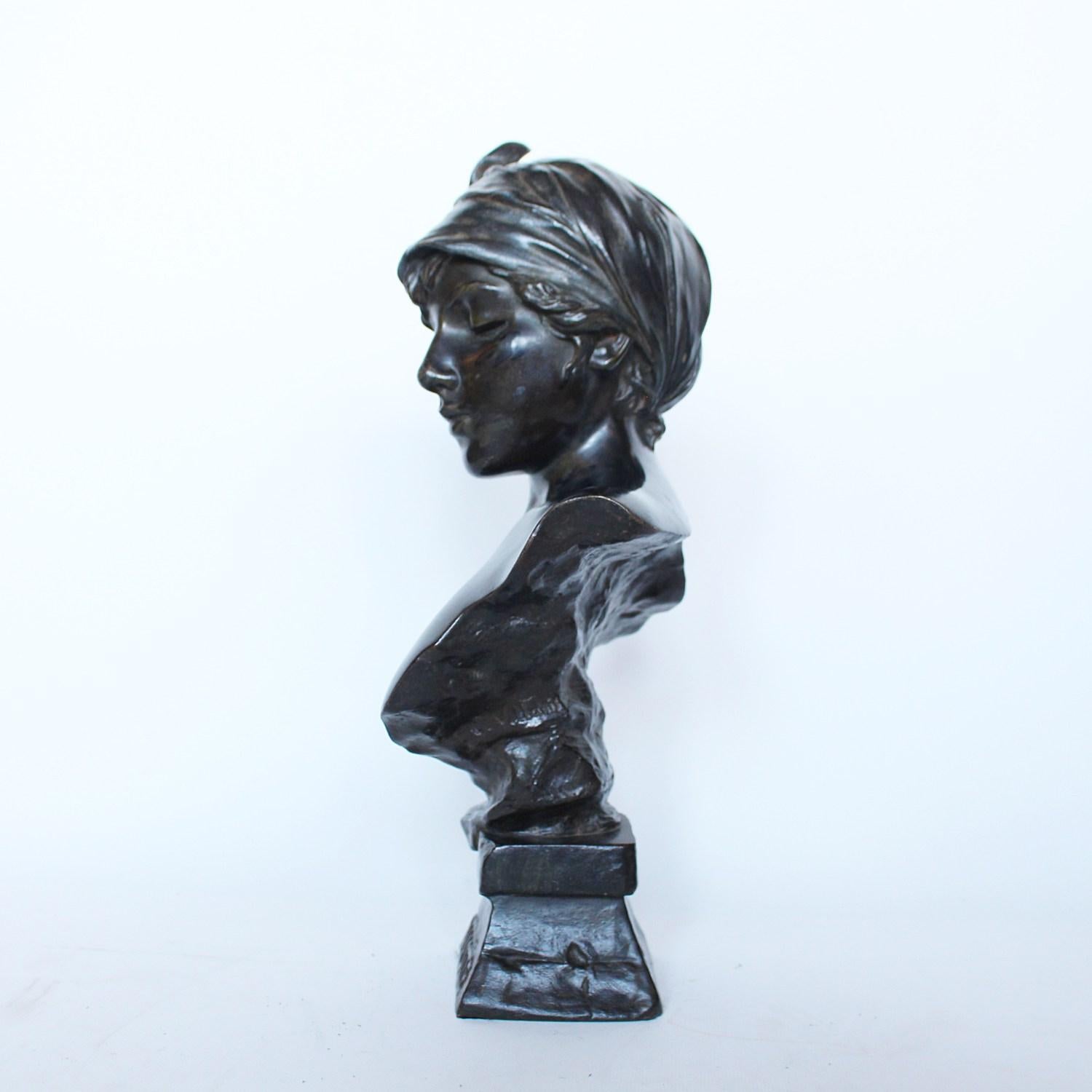 Janotte, un buste Art Nouveau en bronze patiné d'une jeune femme avec un foulard. Patine brun foncé. Posé sur une plinthe intégrale. Signé Villanis sous l'épaule.

Signé Villanis sous l'épaule

Artiste : Emmanuel Villanis,