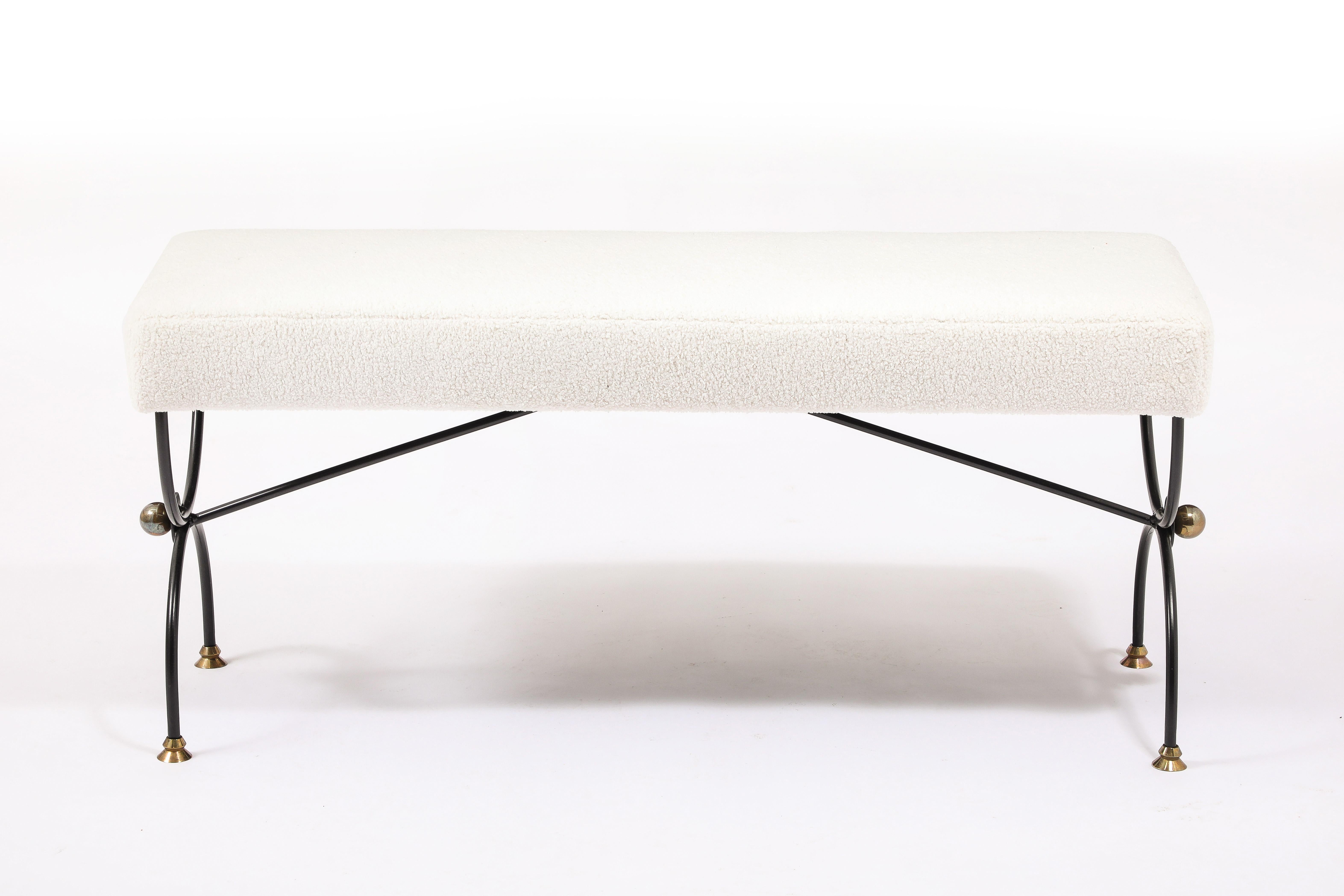 Curule Jansen bench in black enameled wrought iron with bronze accent and feet, the feet are reminiscent of a Giacometti lamp.