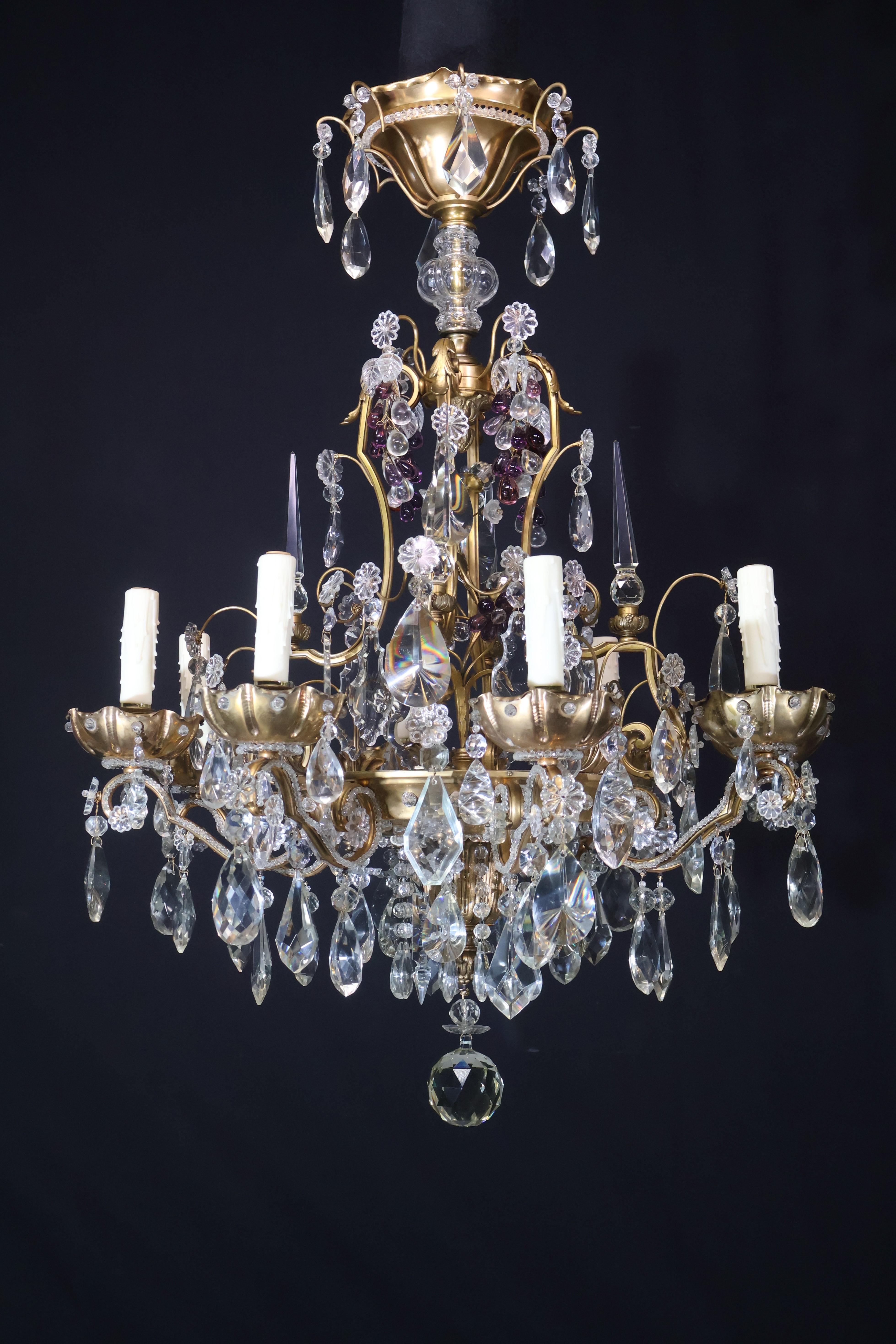 A Very Fine Gilt Bronze Chandelier with hand cut crystal pendalogues, obelisks & fruits by Maison Jansen. 8 lights. 
France, circa 1920
Dimensions: Height 36 1/2
