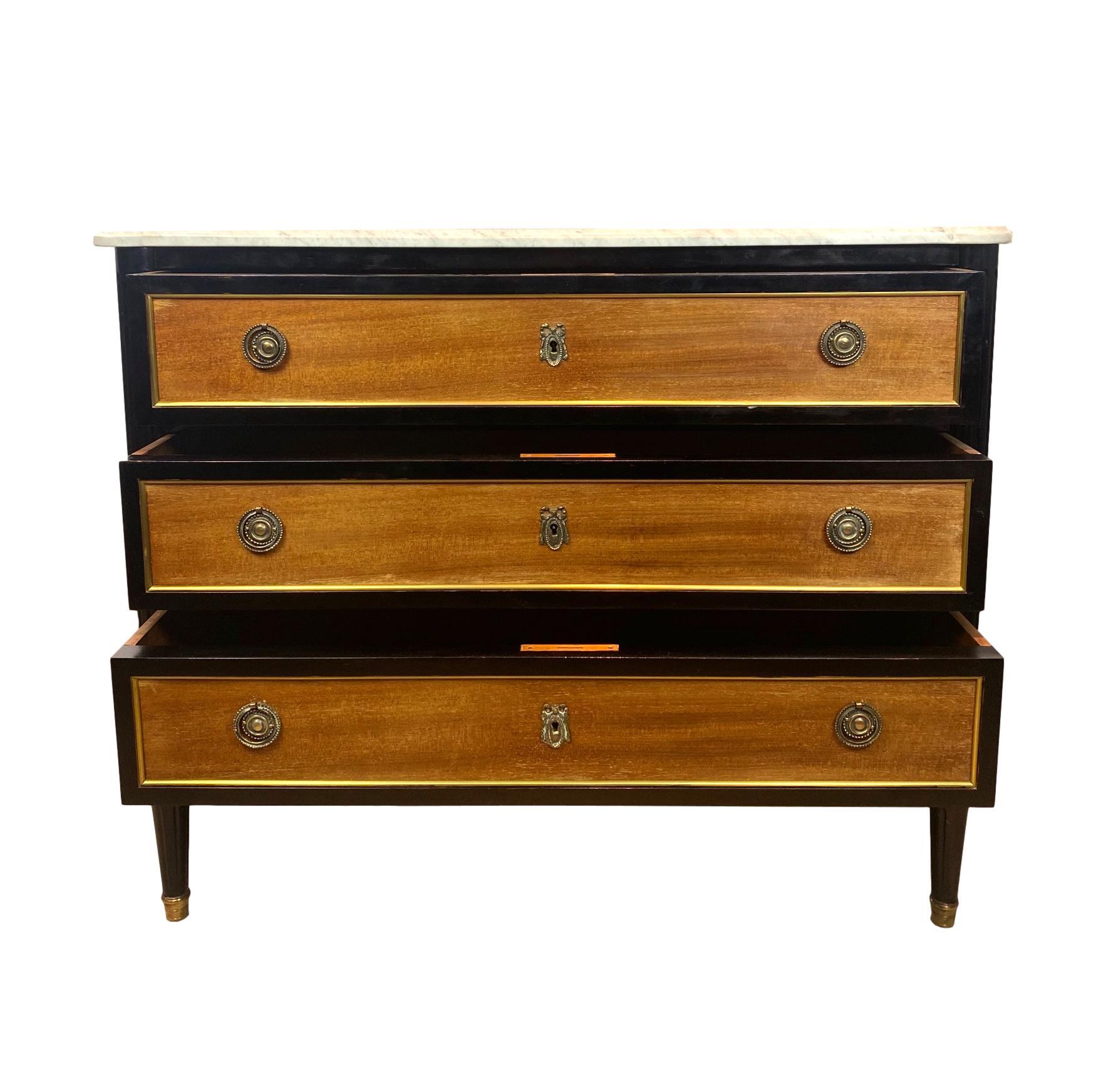 Jansen ebonized and mahogany bronze mounted marble-top commode, French, circa 1940.