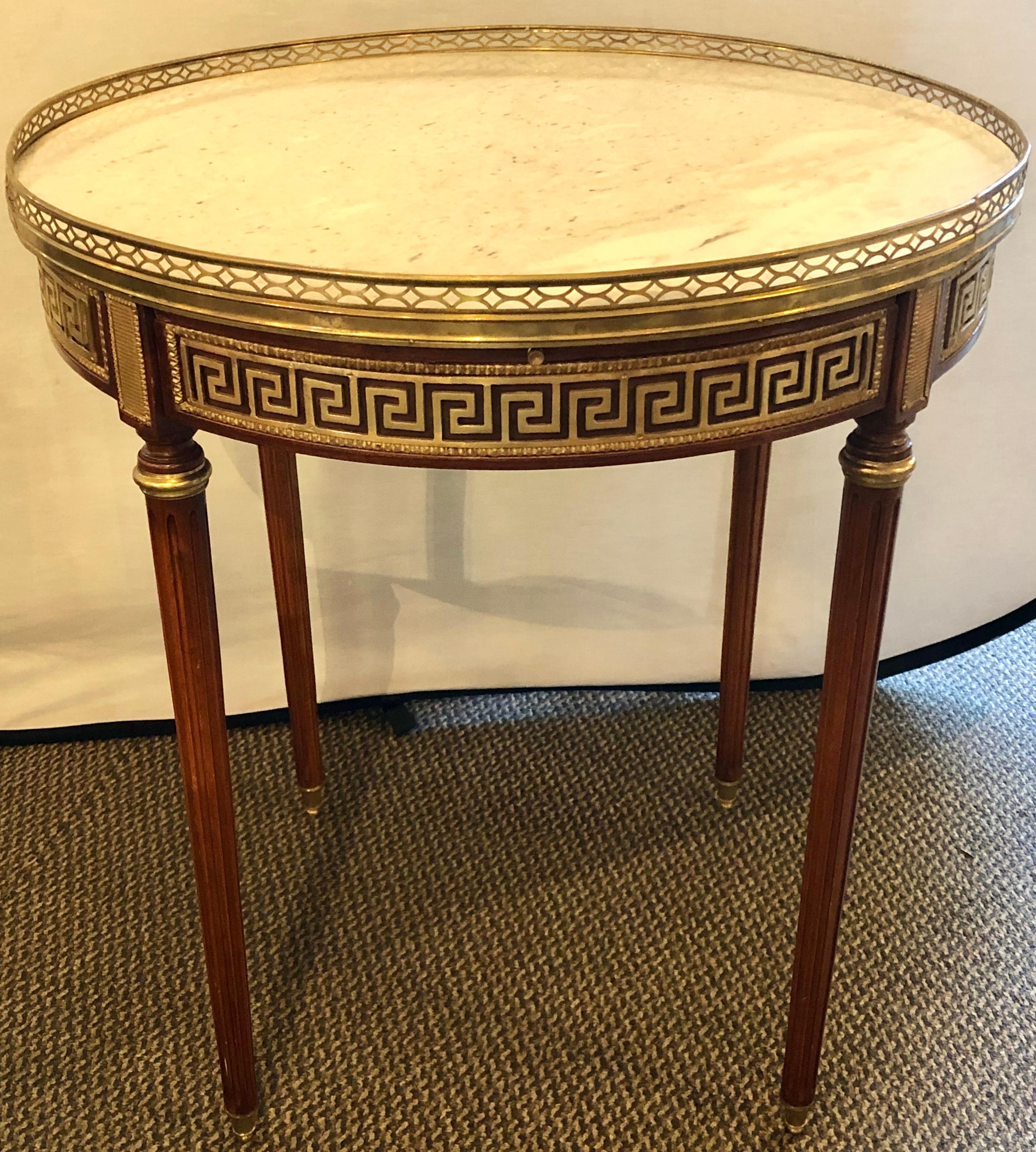 Maison Jansen End, side or Bouillotte tables. These fine Russian neoclassical Greek Key Designed tables are stylish and sleek each having two drawers. The white marble top set in a bronze pierced gallery frame leading to a Greek Key design bronze