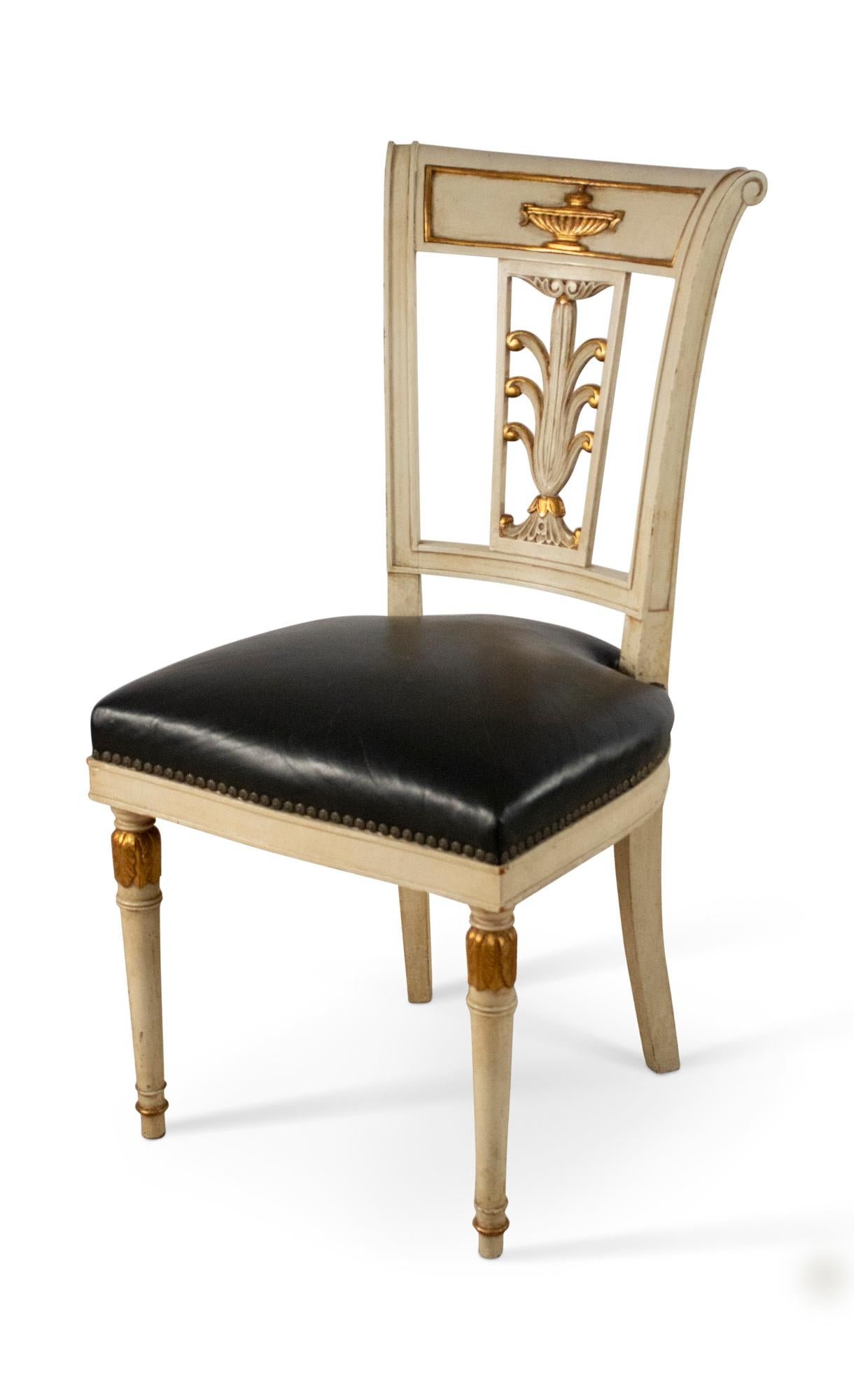 Set of 4 French Directoire-style (mid-20th Century) side chairs with ivory painted and gilt wood frames, giltwood urn and plume design open carved backs, and black leather slip seats. (JANSEN) (priced as set).
      