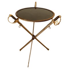 Jansen, Guéridon with sabres, brass and black poaline, circa 1960, France.