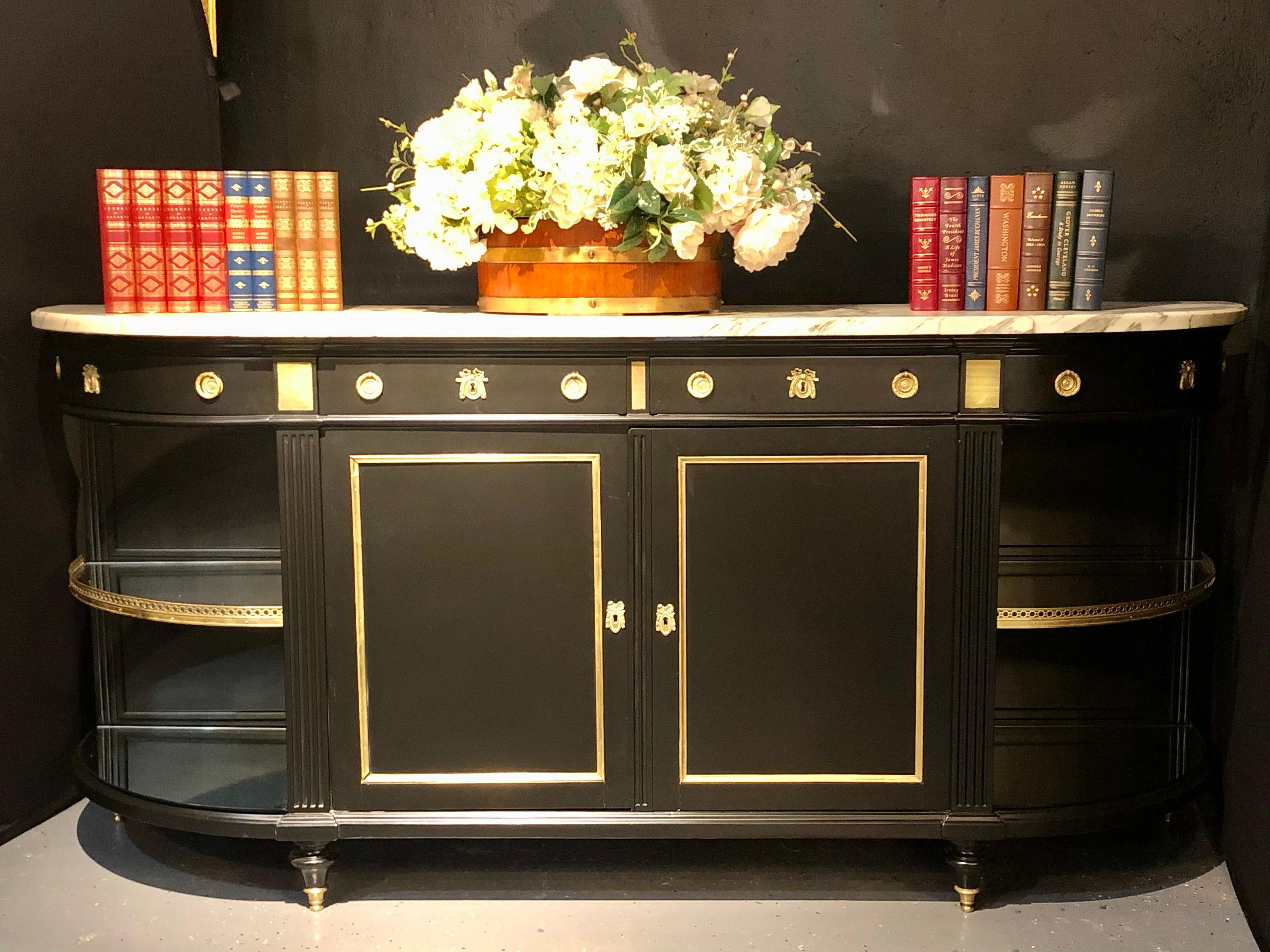 Monumental Hollywood Regency sideboard, console in the manner of Maison Jansen. This fully refinished sideboard is impressive in size and most assuredly quality. The ebony flat finish is simply stunning as it supports a white and gray veined think