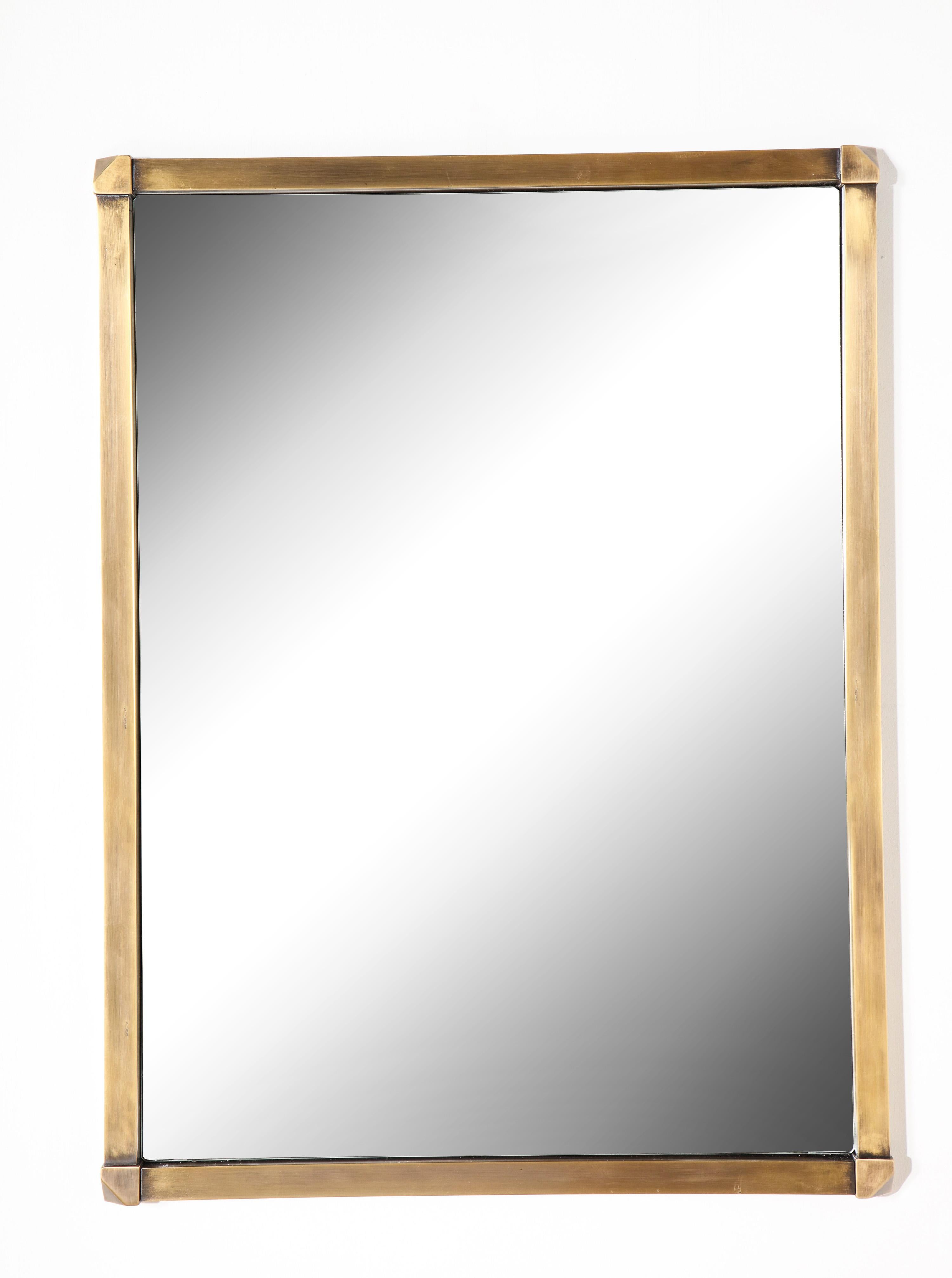 Patinated brass mirror with cubist corner accents by Jansen.