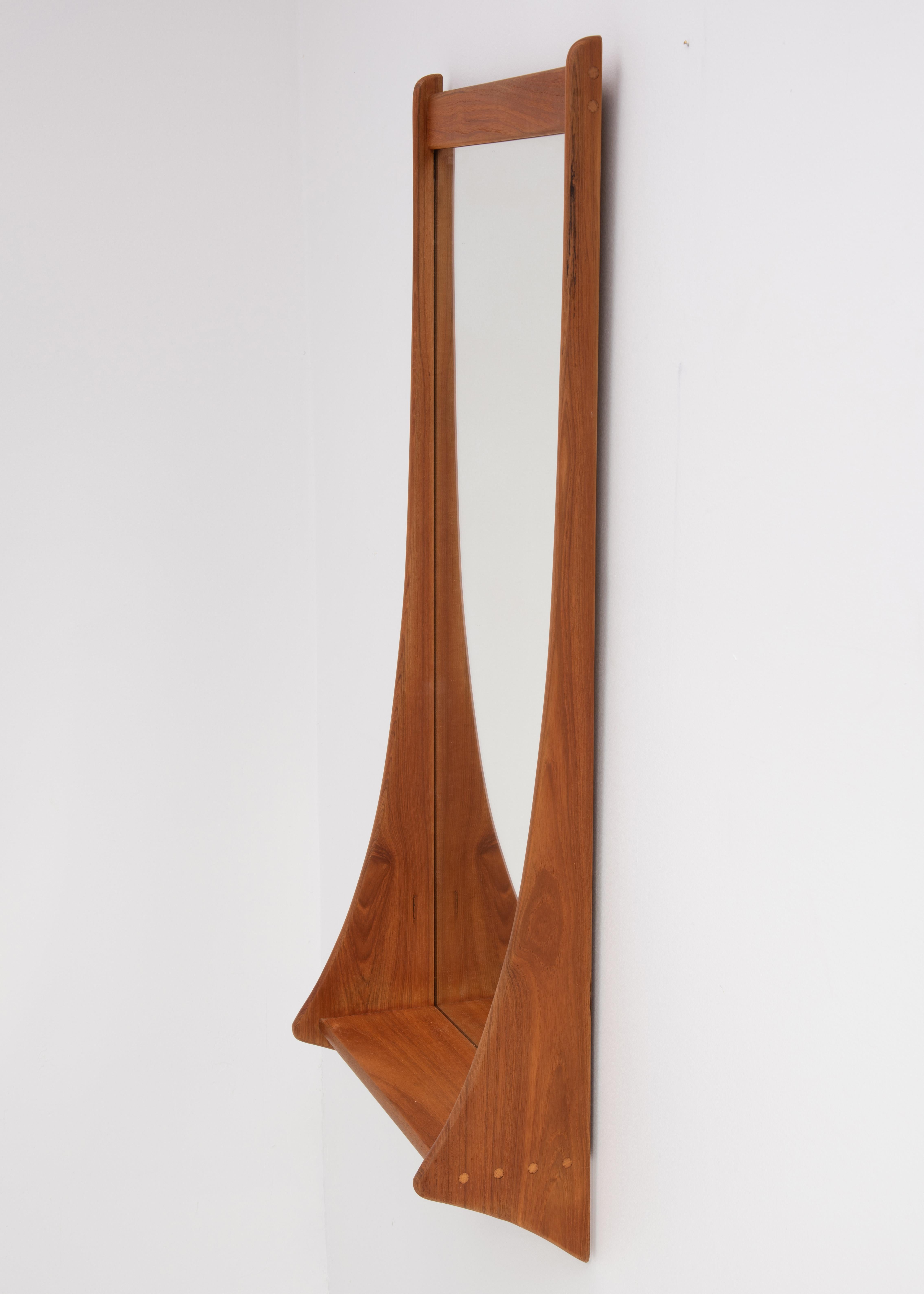 A Mid Century teak wall mirror with shelf, made by Jansen Spejle and marked 