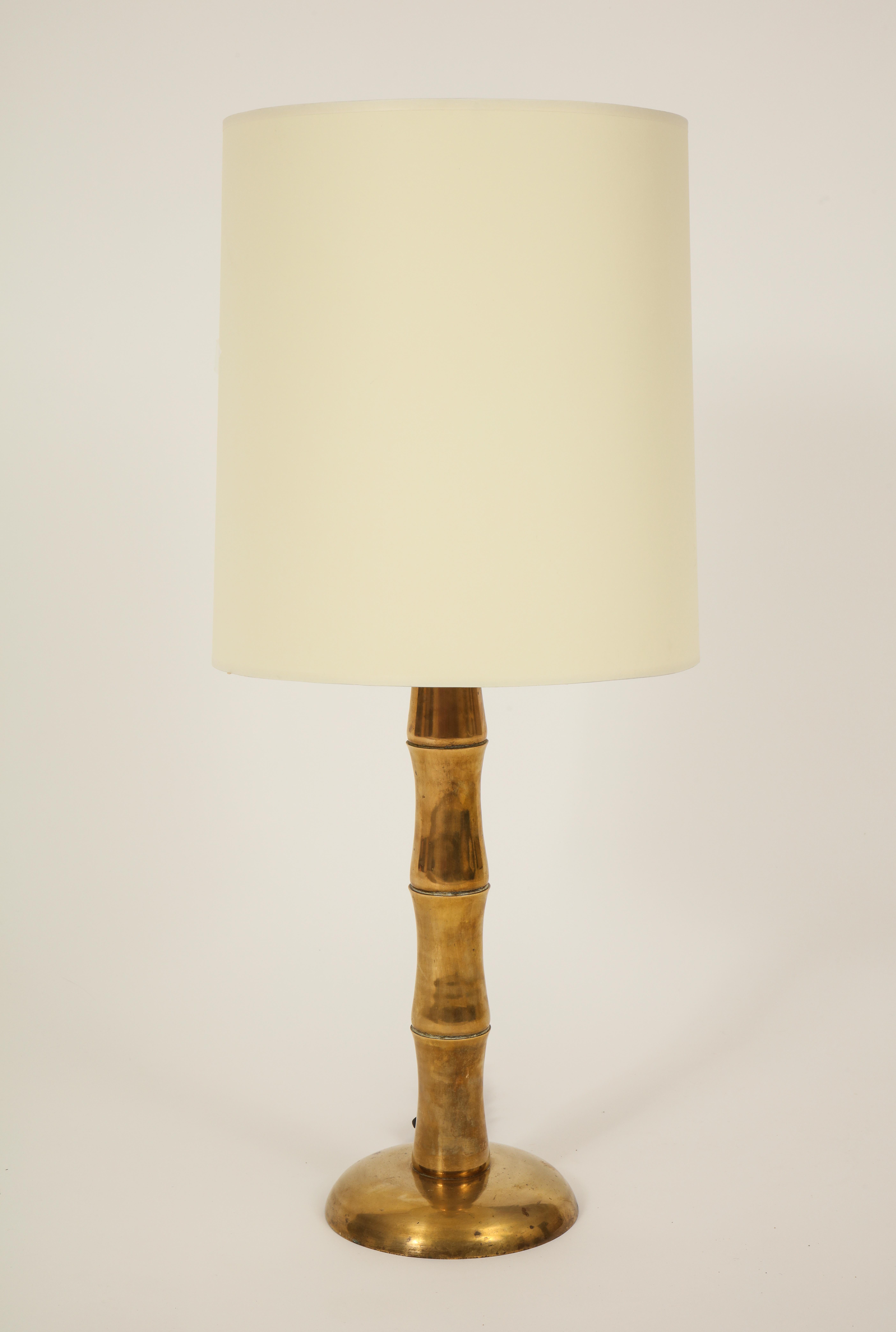Jansen style bamboo brass French midcentury pair of table lamps.

Beautiful pair of brass lamps with perfect patina to the brass as shown in photos. The perfect height and look to any decor. Rewired for US. Silk Black cord attachment.
Shades not