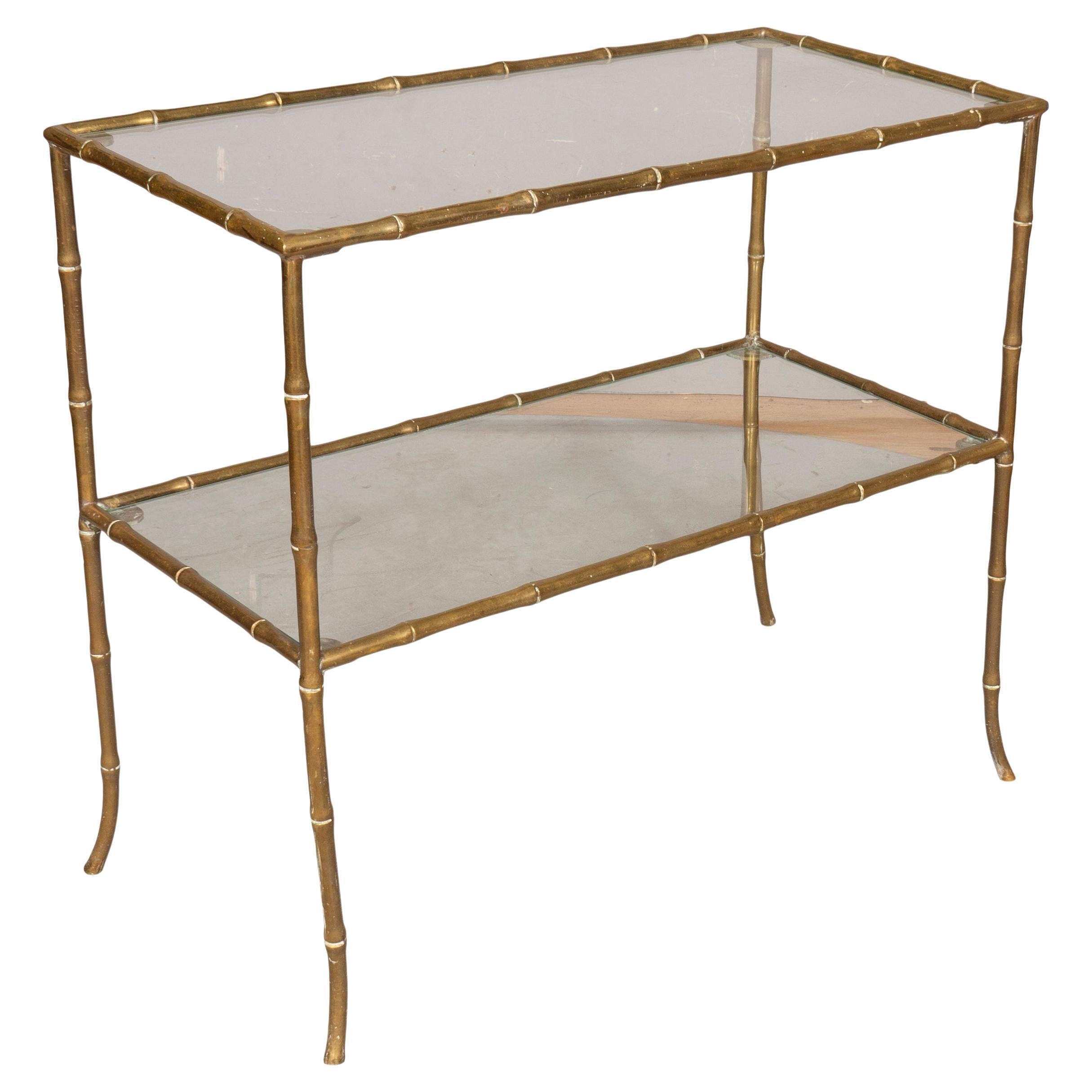 Two tier with glass shelves. Cast brass frame and legs in faux bamboo design.