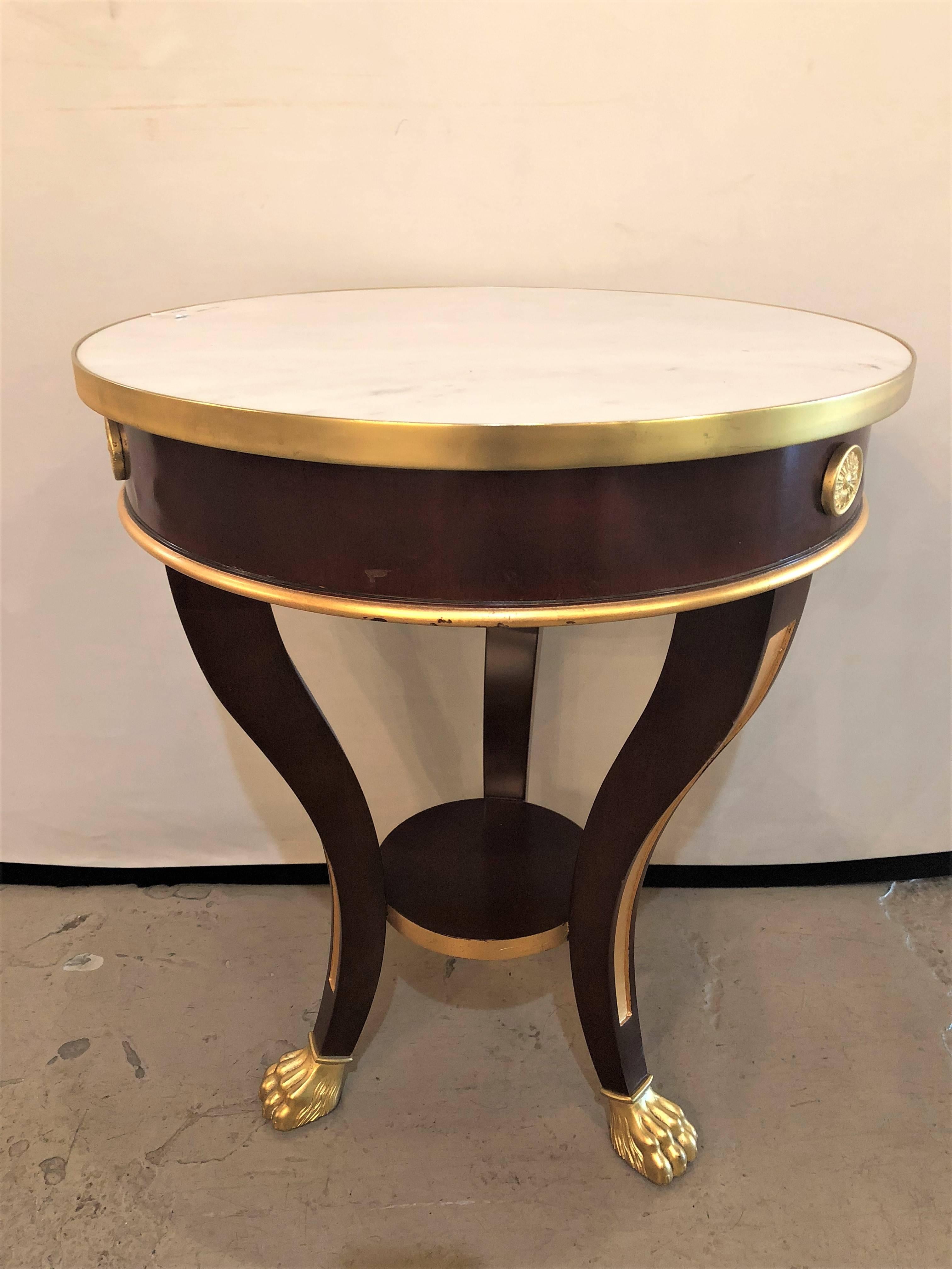 A small Maison Jansen style claw foot and bronze mounted marble-top circular end or side table. 

Mahogany, Bronze, Marble
France, 1940s