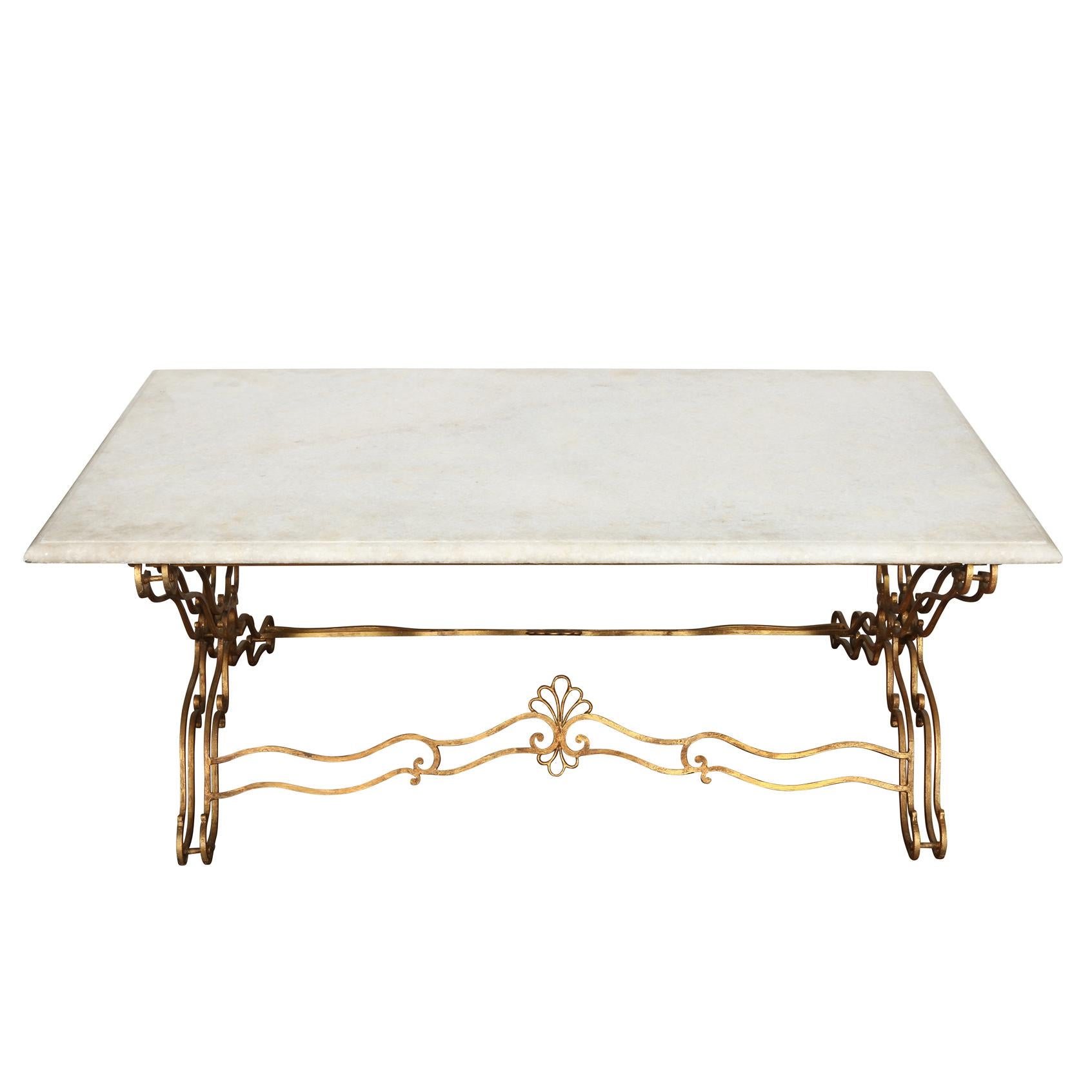 Jansen style, intricately curved gilt metal X-base white marble top coffee table.