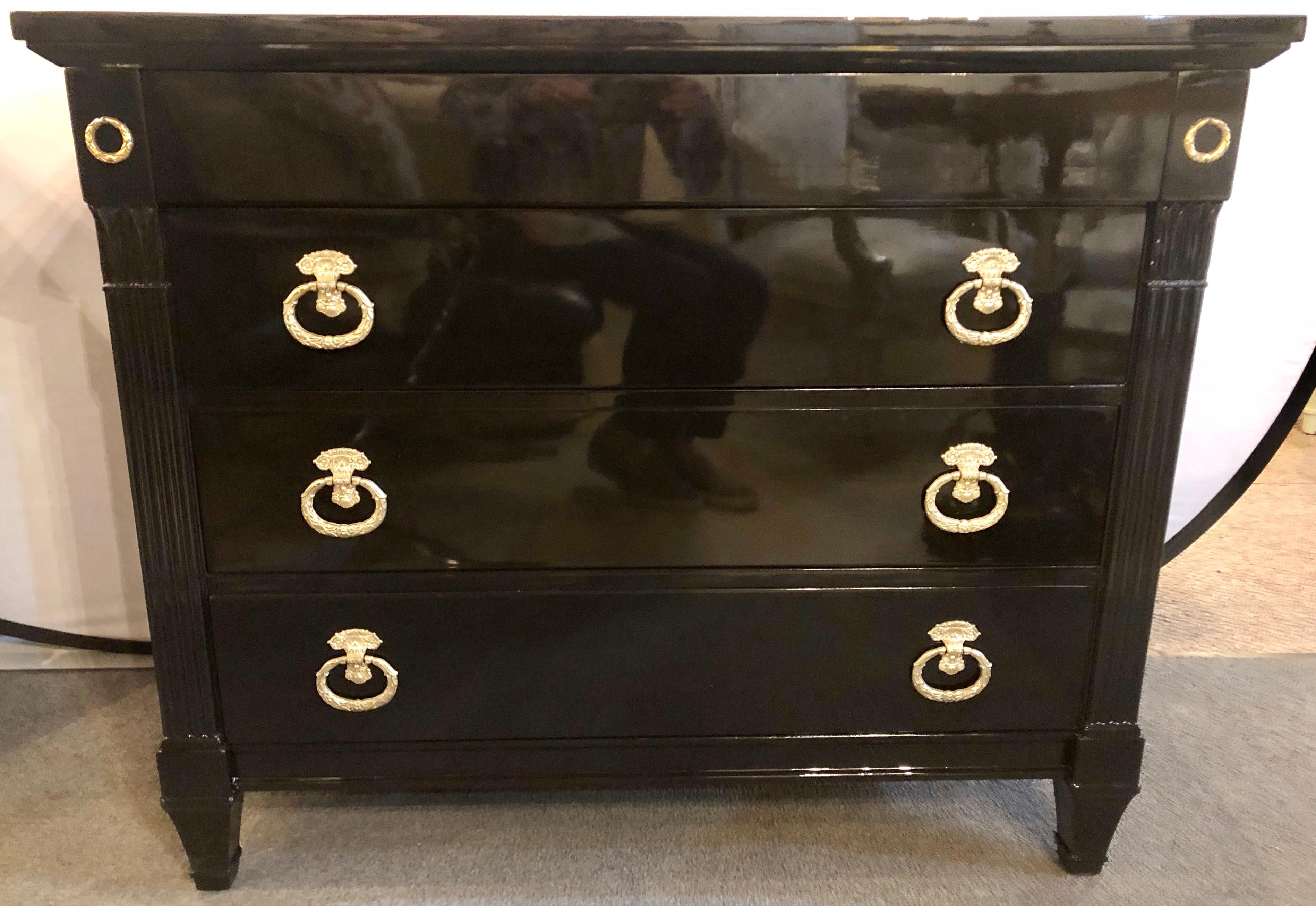 Maison Jansen Style Hollywood Regency Ebony Commodes, Chests or Nightstands. A Pair of the finest finish commodes anyone could ask for. The Steinway finished black lacquered tops supported by a group of four drawers drawers the top with hidden pulls