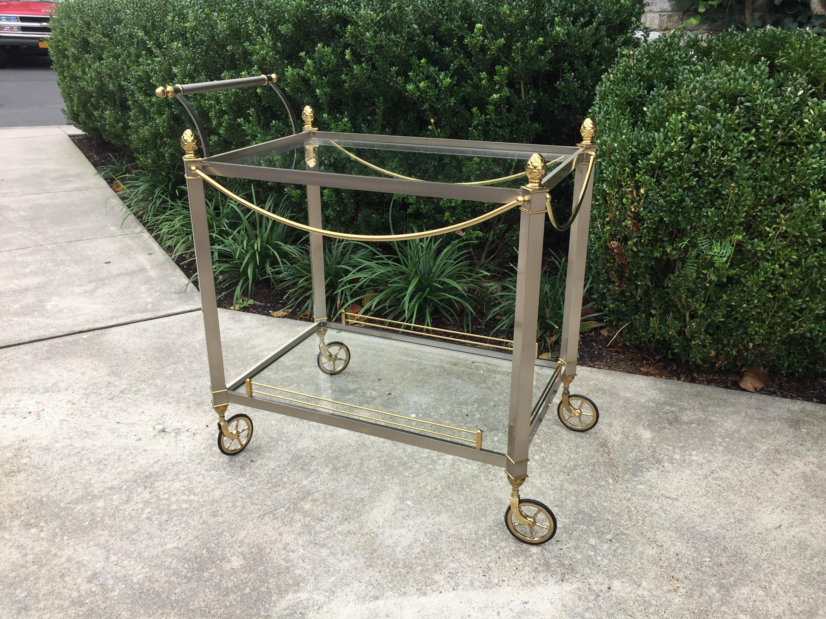 Brushed steel and brass blended in this beautiful and elegant bar/ tea cart (Marked Italy). Two levels and wheels move easily.

Height of bar handle is 33.5 inches