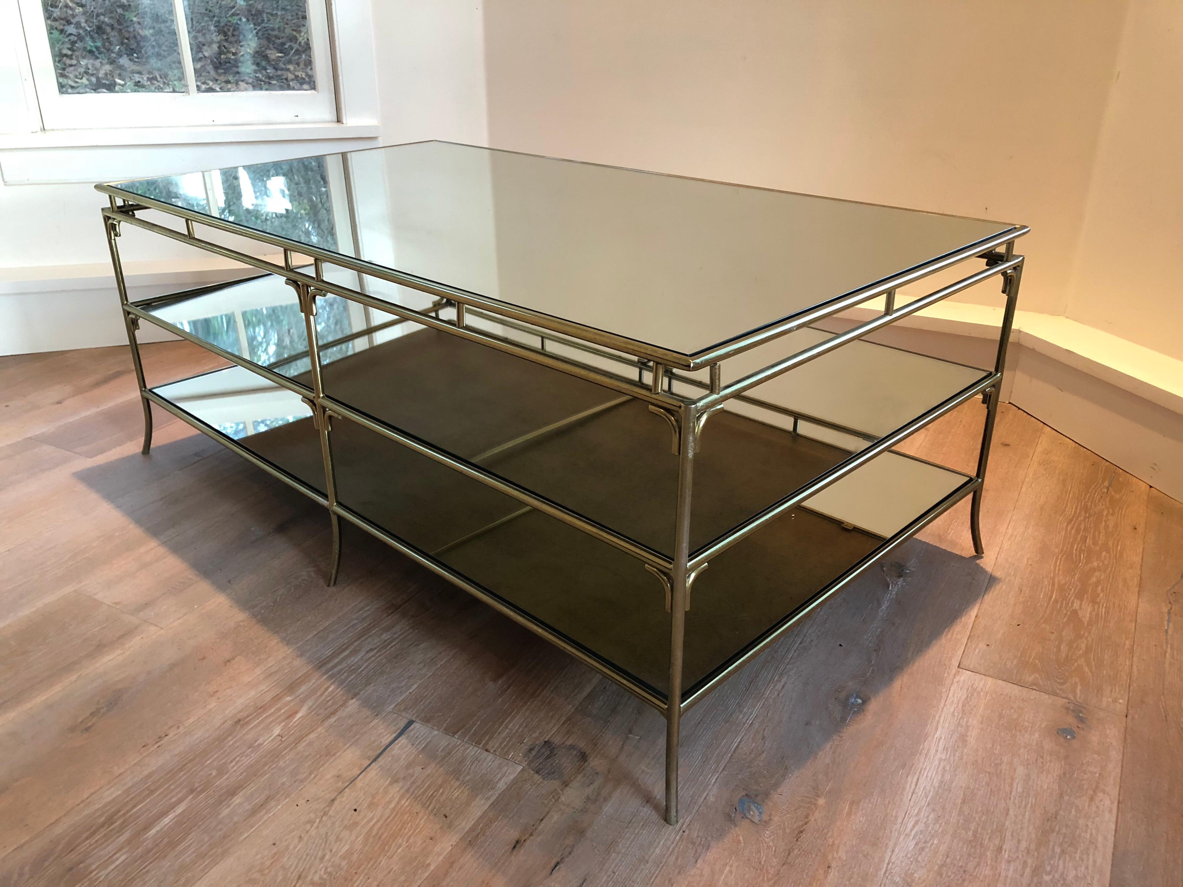 A Jansen style three-tier cocktail table. Heavy brass frame with thick mirrored tiers. Excellent scale and quality.