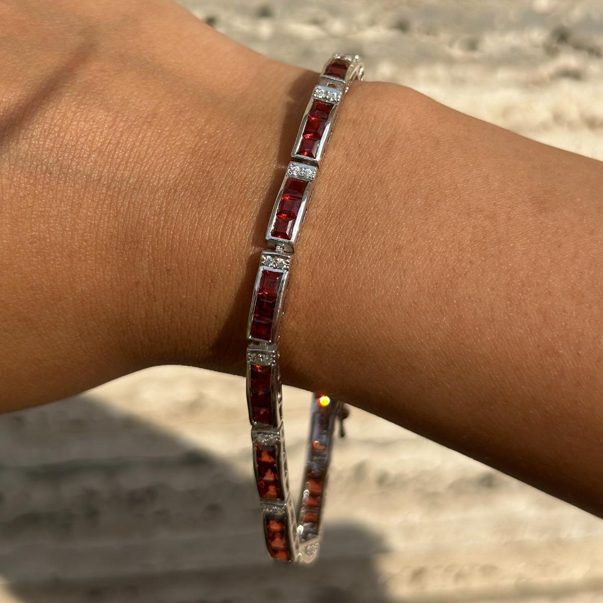 January Birthstone Garnet and Diamond Bracelet in Sterling Silver showcases endlessly sparkling natural garnet, weighing 8.10 carat. It measures 7.5 inches long in length. 
Garnet improves mental strength.
Designed with perfect square cut garnet
