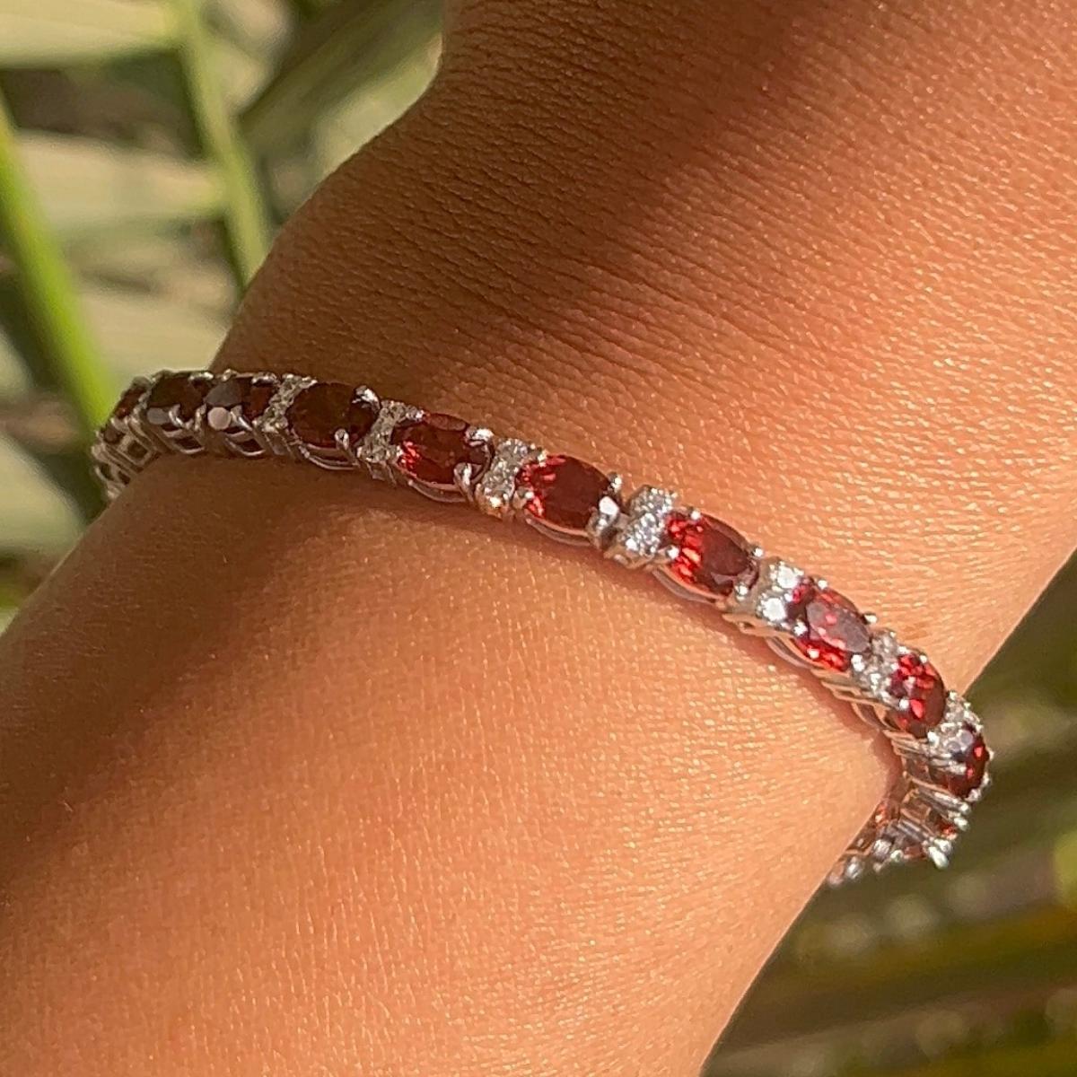 Garnet January Birthstone Tennis Bracelet in 925 Sterling Silver. You shall need statement tennis bracelet to make a statement with your look. Each piece features dazzling cubic zirconia stones, renowned for their brilliance and clarity, set in