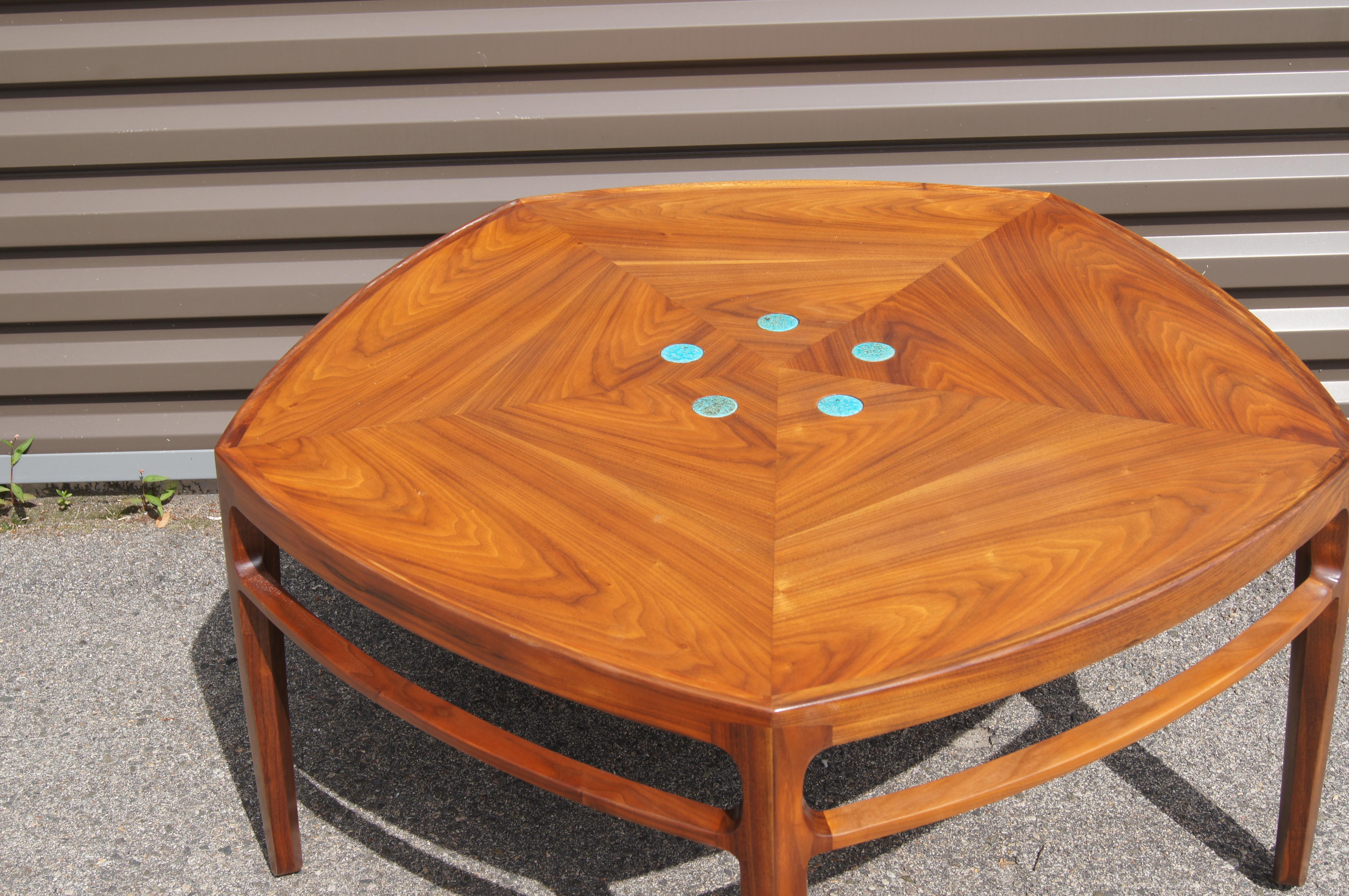 Designed by Edward Wormley in 1957 as part of Dunbar's Janus Collection, this fabulous walnut coffee table, model 5625N, features a pentagonal frame inset with five blue ceramic tiles by Gertrud and Otto Natzler.

The metal Dubar label is found