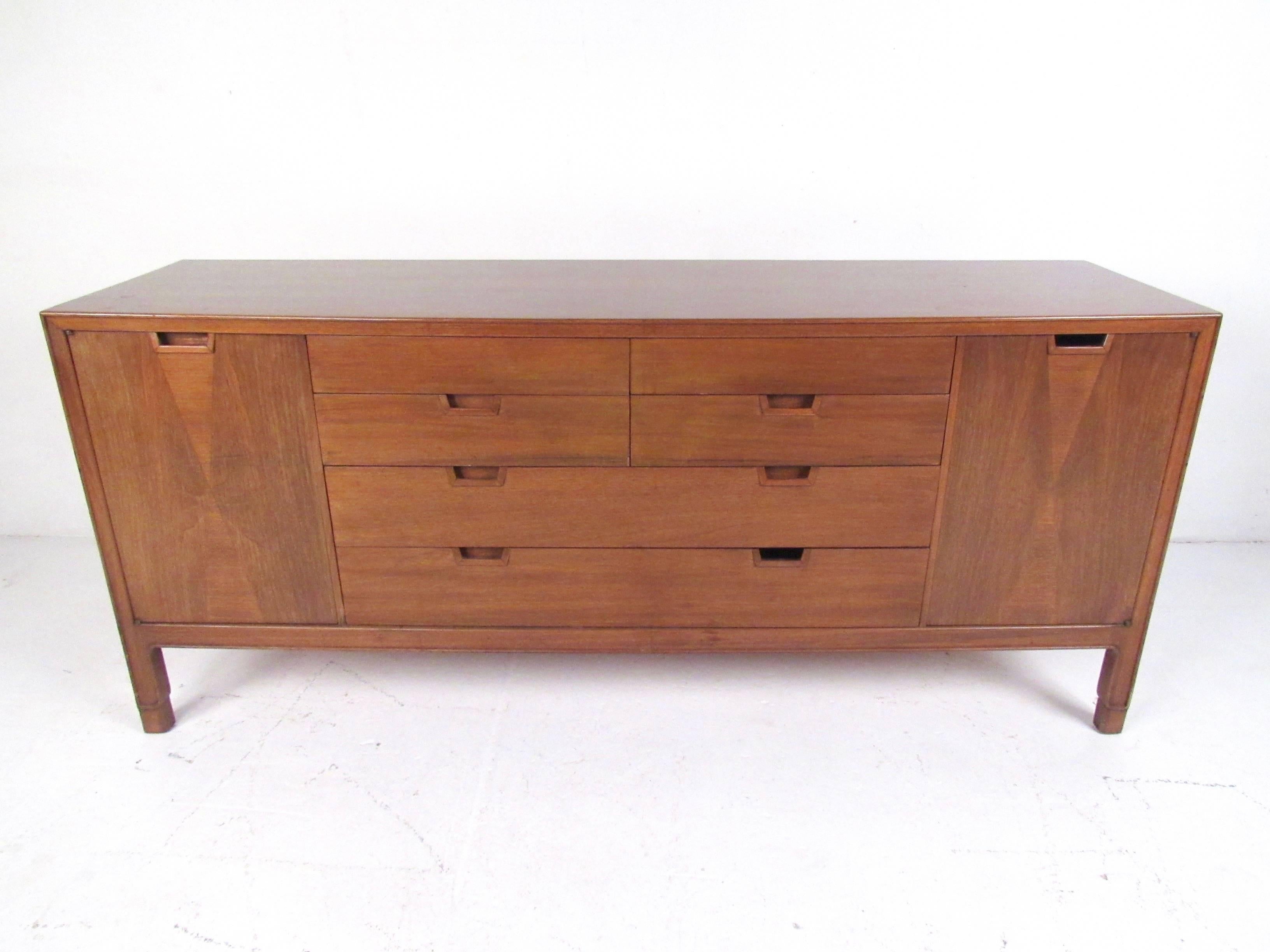 This John Stuart bedroom dresser features vintage walnut finish and timeless Mid-Century Modern style. From the 