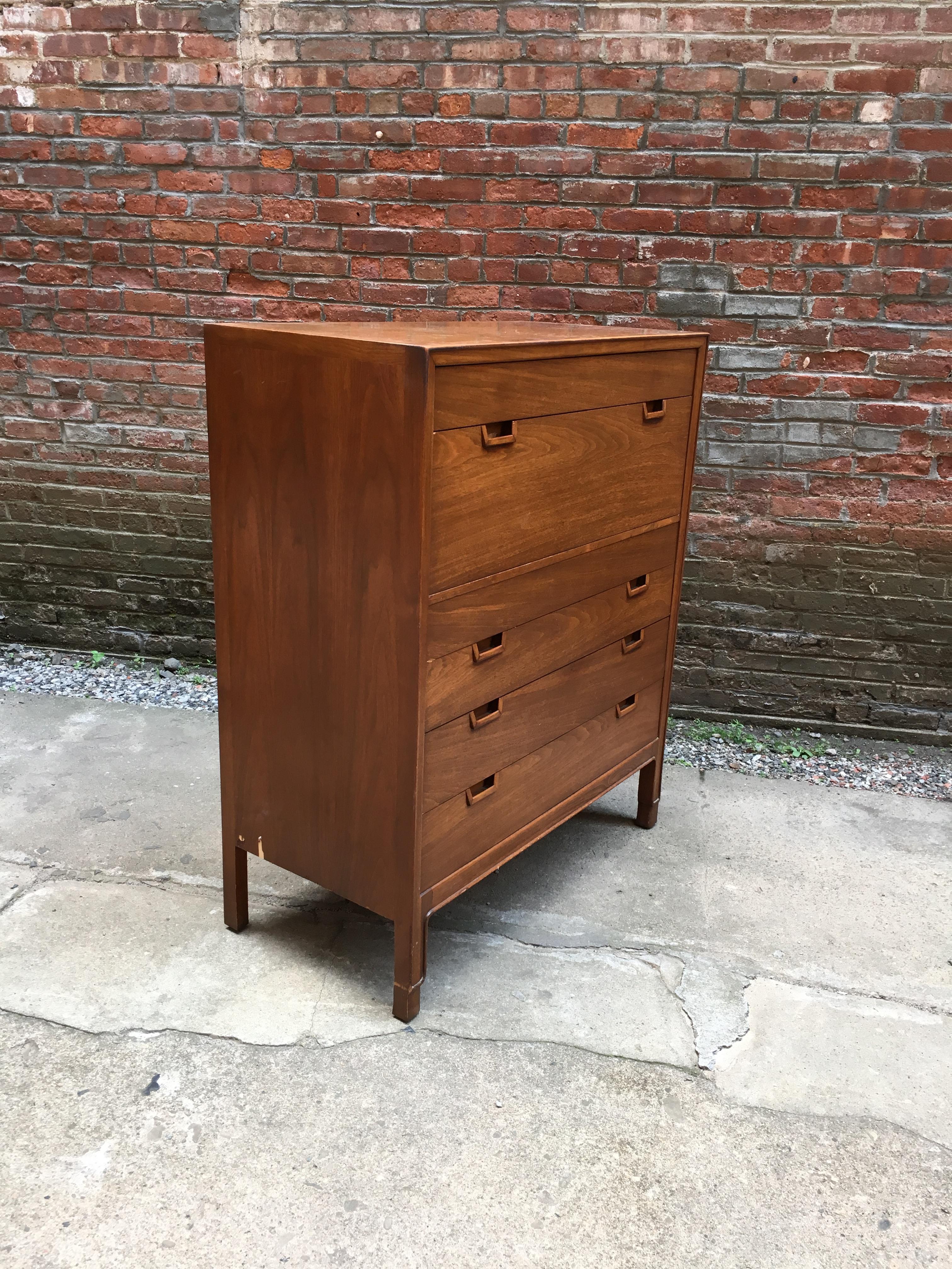 Beautiful solid and veneer walnut construction, circa 1955-1960. Six drawers on nicely carved legs. Banded veneer edge on top. Recessed handles. Oak secondary wood. Signed with burn in Janus stamp and John Stuart enamel button. Nice original