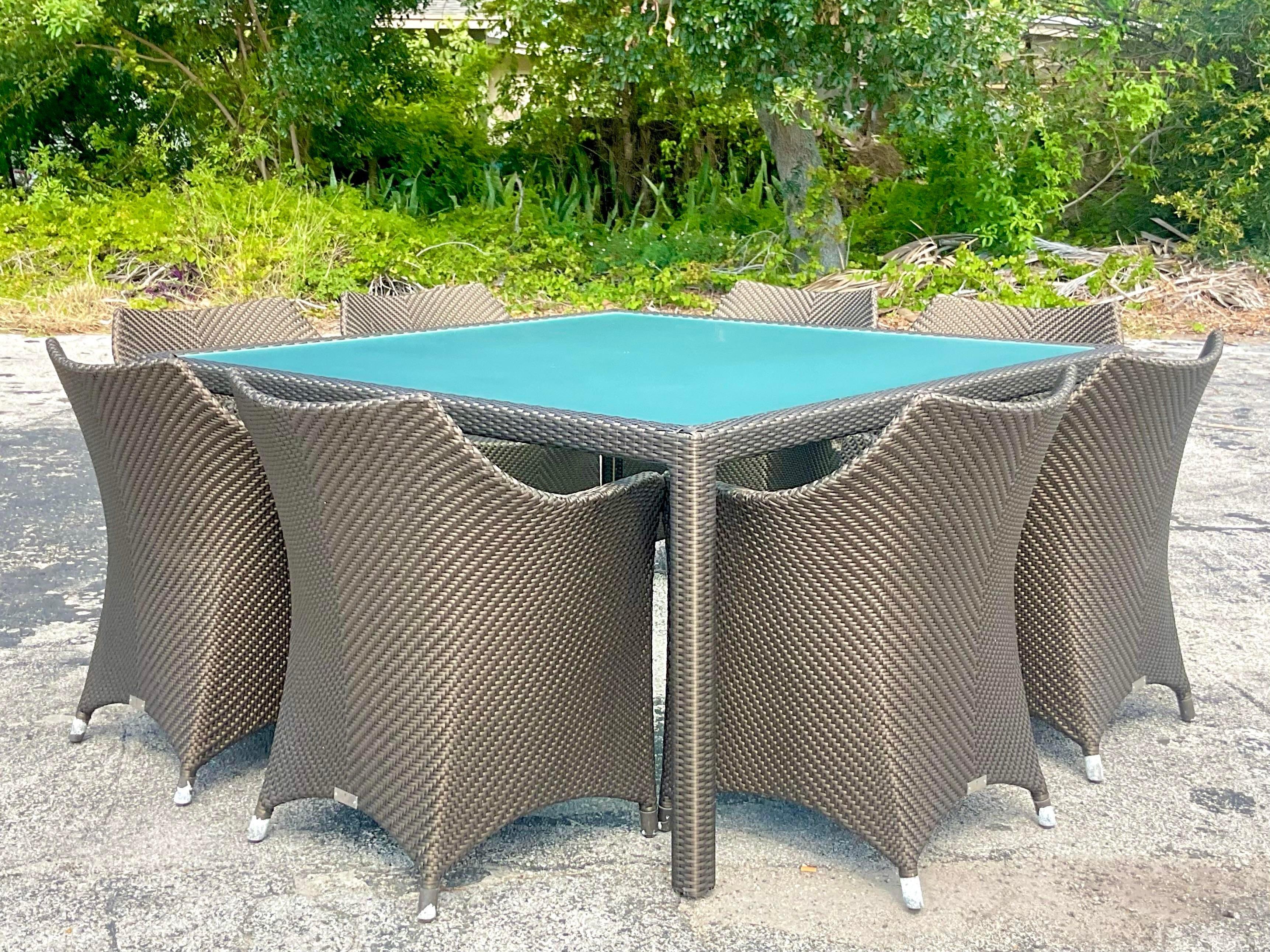 A spectacular set of vintage Coastal Dining table and 8 chairs. Made by the legendary Janus Et Cie and tagged on each chair. The Amari Vita Bronze collection with a very subtle shimmer. Pure luxury. A chic woven resin rattan for extra durability.