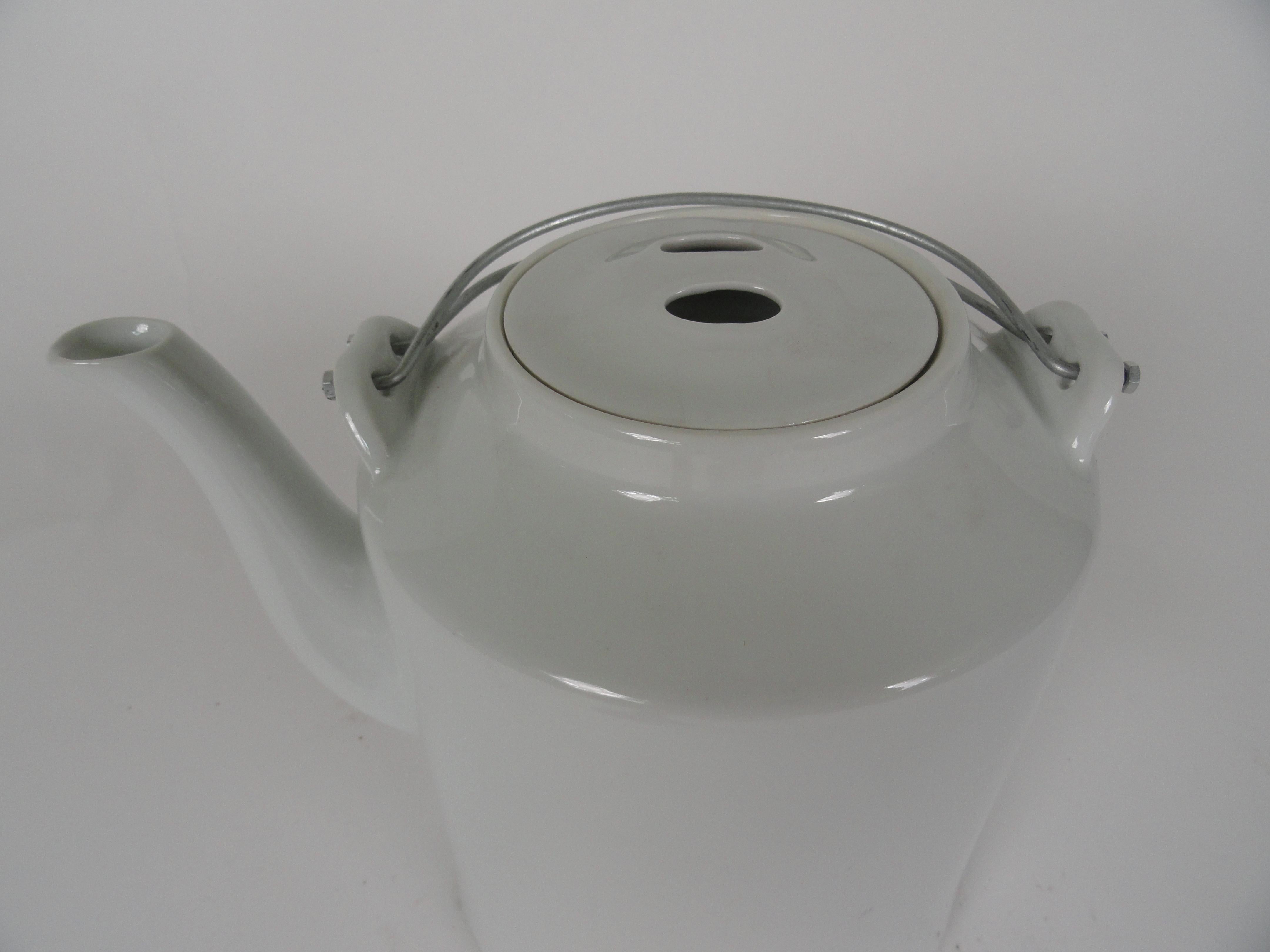 Contemporary large scale Blanc de Chin teapot from Janus et Cie. Has two thin metal handles and removable lid. Large scale. Stamp on bottom.