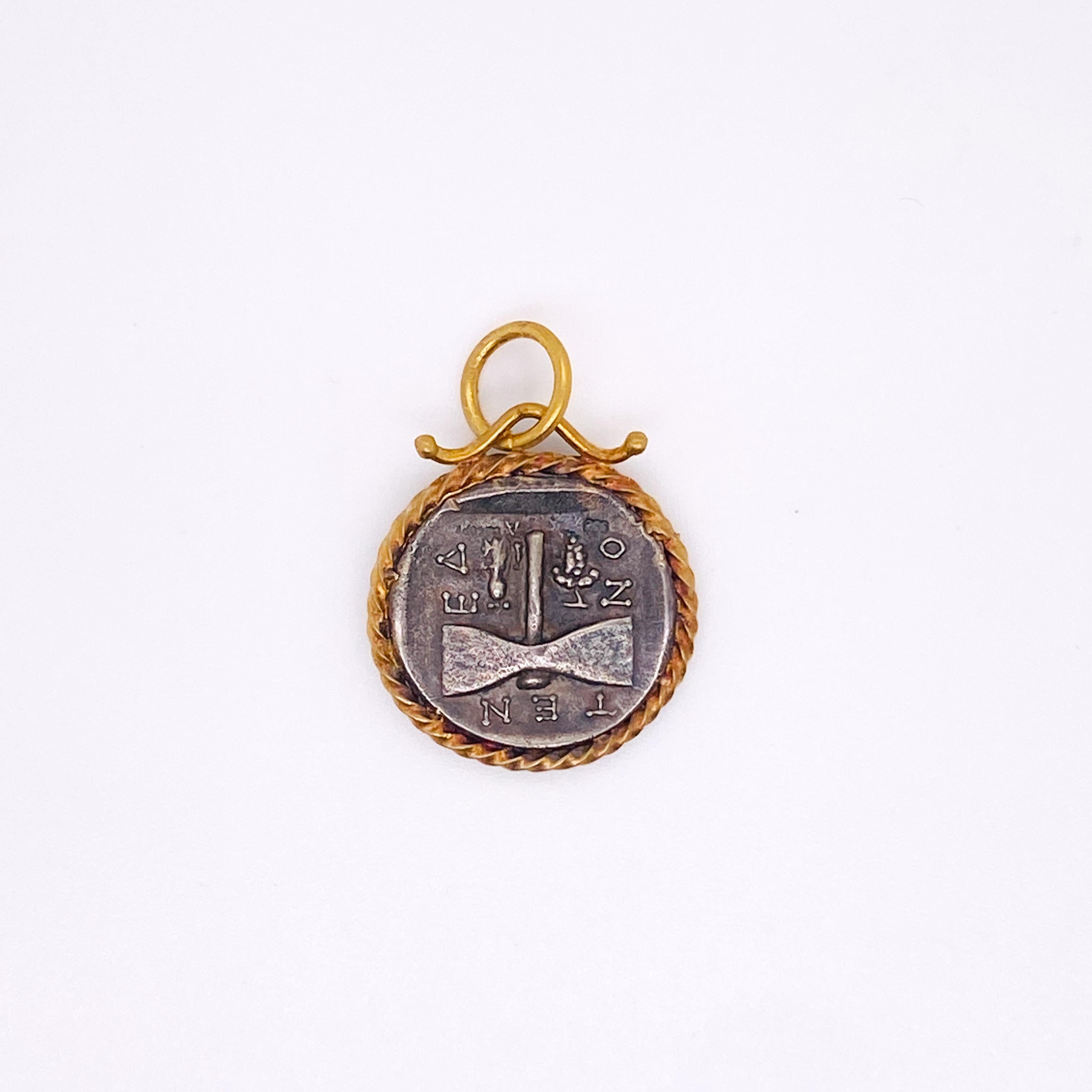 God of Janus is known for its transitions and dualities. There is a separate picture on each side of the coin. Enhanced with a 24 karat gold bezel and ring, this pendant has interest, texture and strong meaning. The pendant comes without a chain but