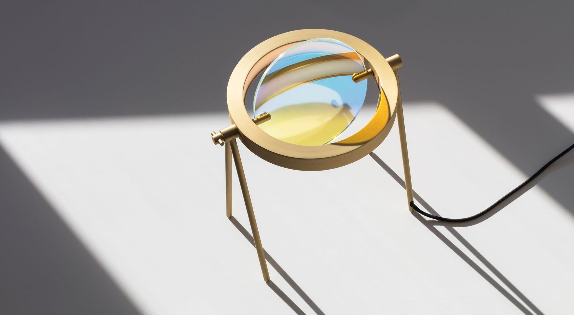 Janus, one of Saturn’s outermost rings, is the eponym and inspiration for this table lamp, Trueing's inaugural product. With an adjustable shade of glass at its centre, the lamp’s luminous brass ring shines inwards to create an aurora-like