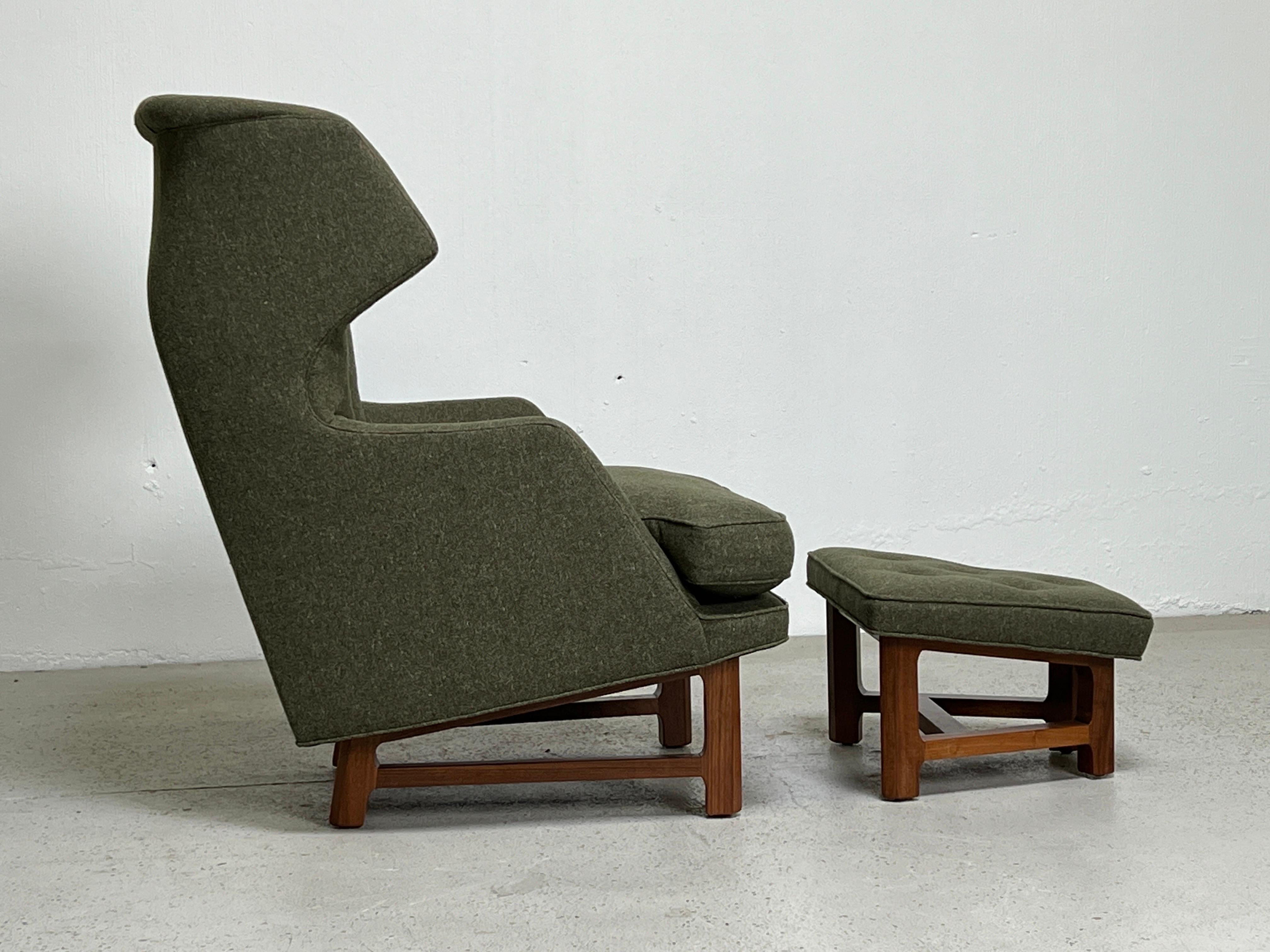 Edward Wormley for Dunbar Janus wing chair and ottoman with walnut bases. Reupholstered in Knoll Melange wool / Sprout. Down seat cushion.
