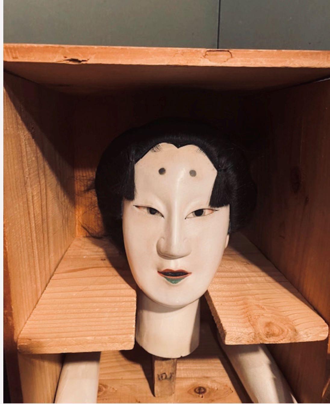 Imperial Bunraku puppet of a young, beautiful princess. Carved from wood and adorned with layers of gofun (oyster shell lacquer), human hair, Sky Imperial eyebrows (dots), penetrating mica eyes, and Imperial green lips. Resting in her storage box,