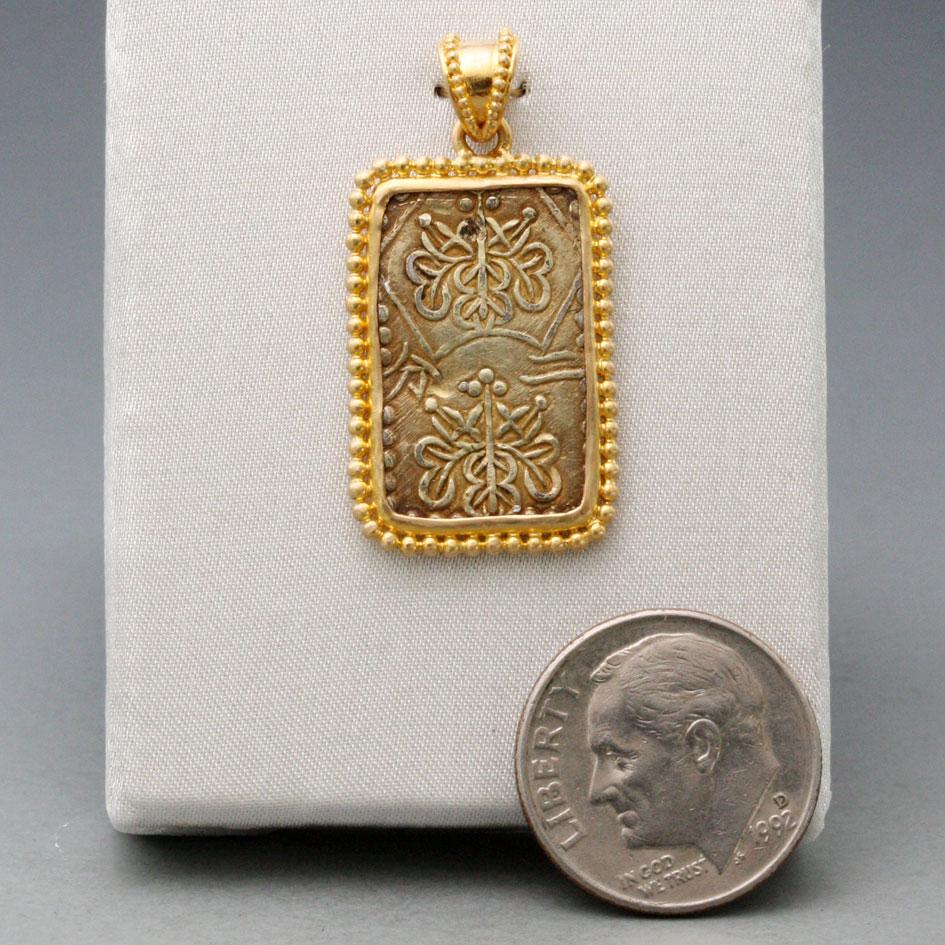 An interesting rectangular gold coin from the last Japanese shogunate, minted in the waning days of their power 1837-1854, is mounted within a Steven Battelle designed 