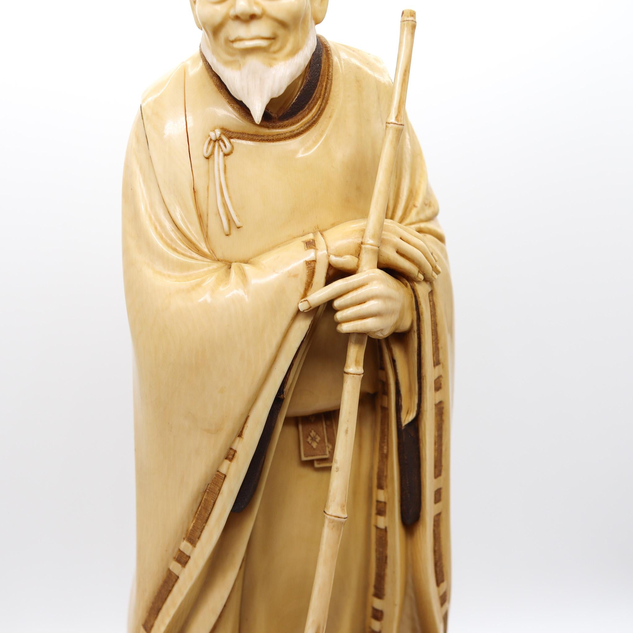 Japanese Japan 1890 Meiji Carved Sculpture of a Dressed Monk With a Rake For Sale