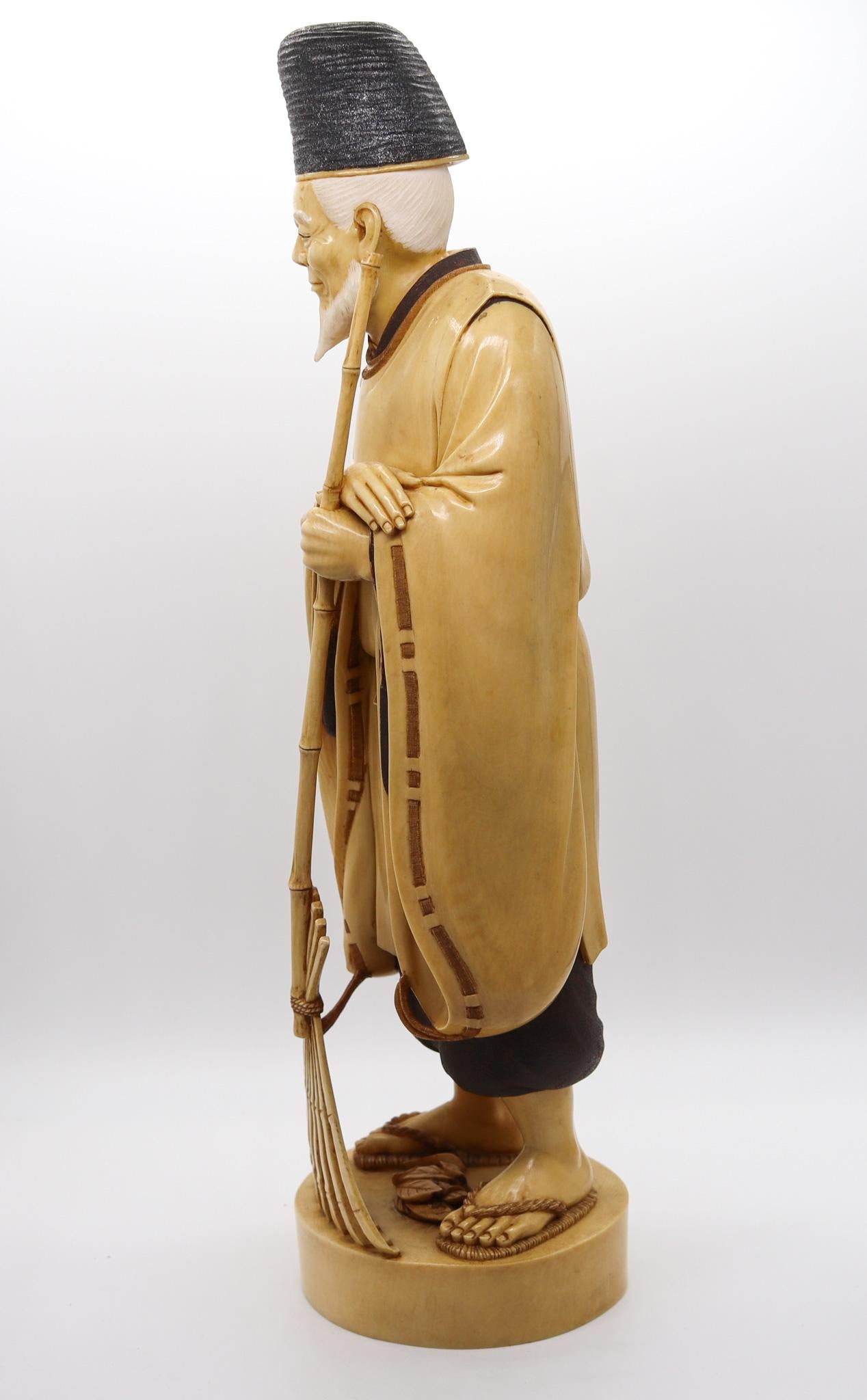 Japan 1890 Meiji Carved Sculpture of a Dressed Monk With a Rake In Excellent Condition In Miami, FL