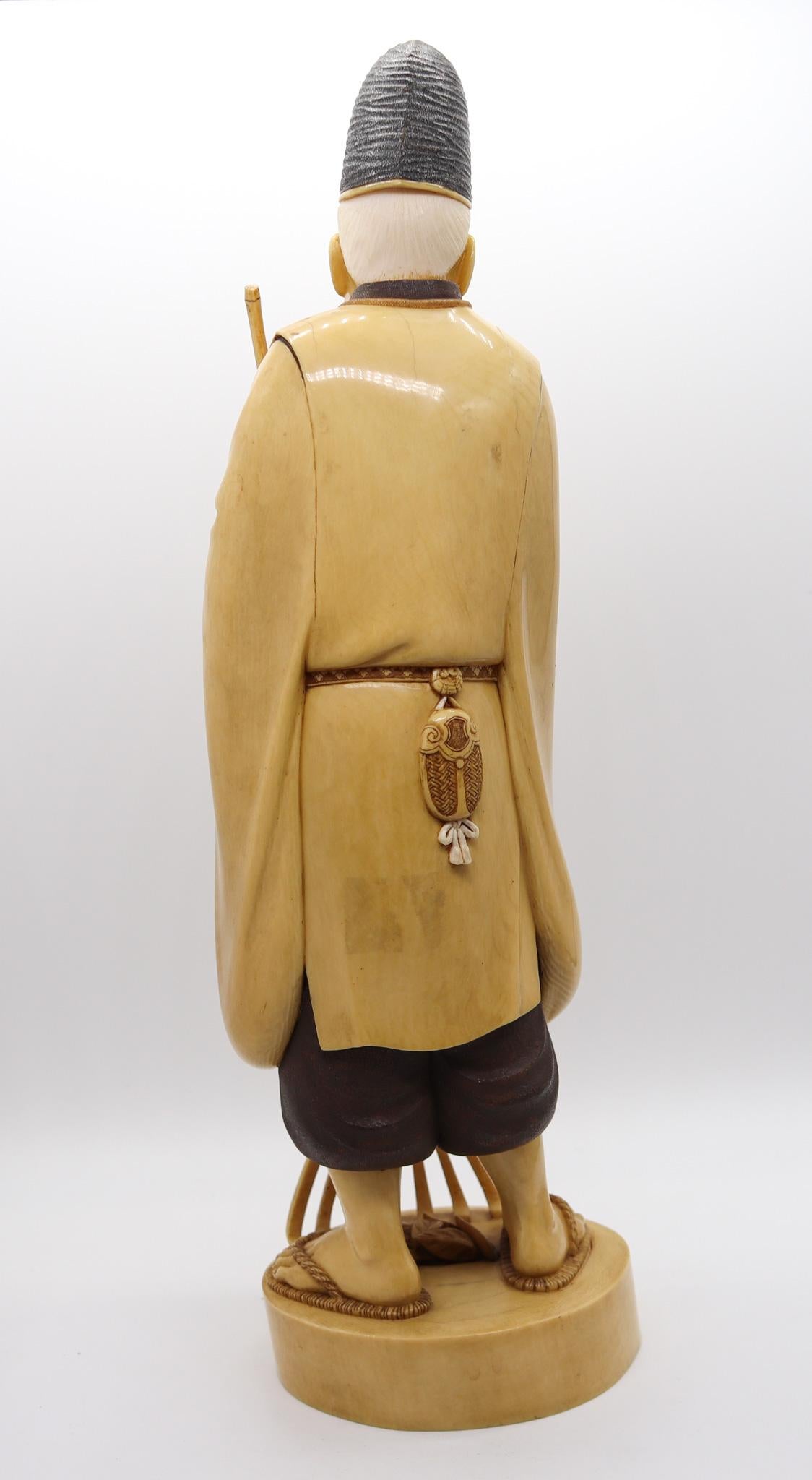 19th Century Japan 1890 Meiji Carved Sculpture of a Dressed Monk With a Rake