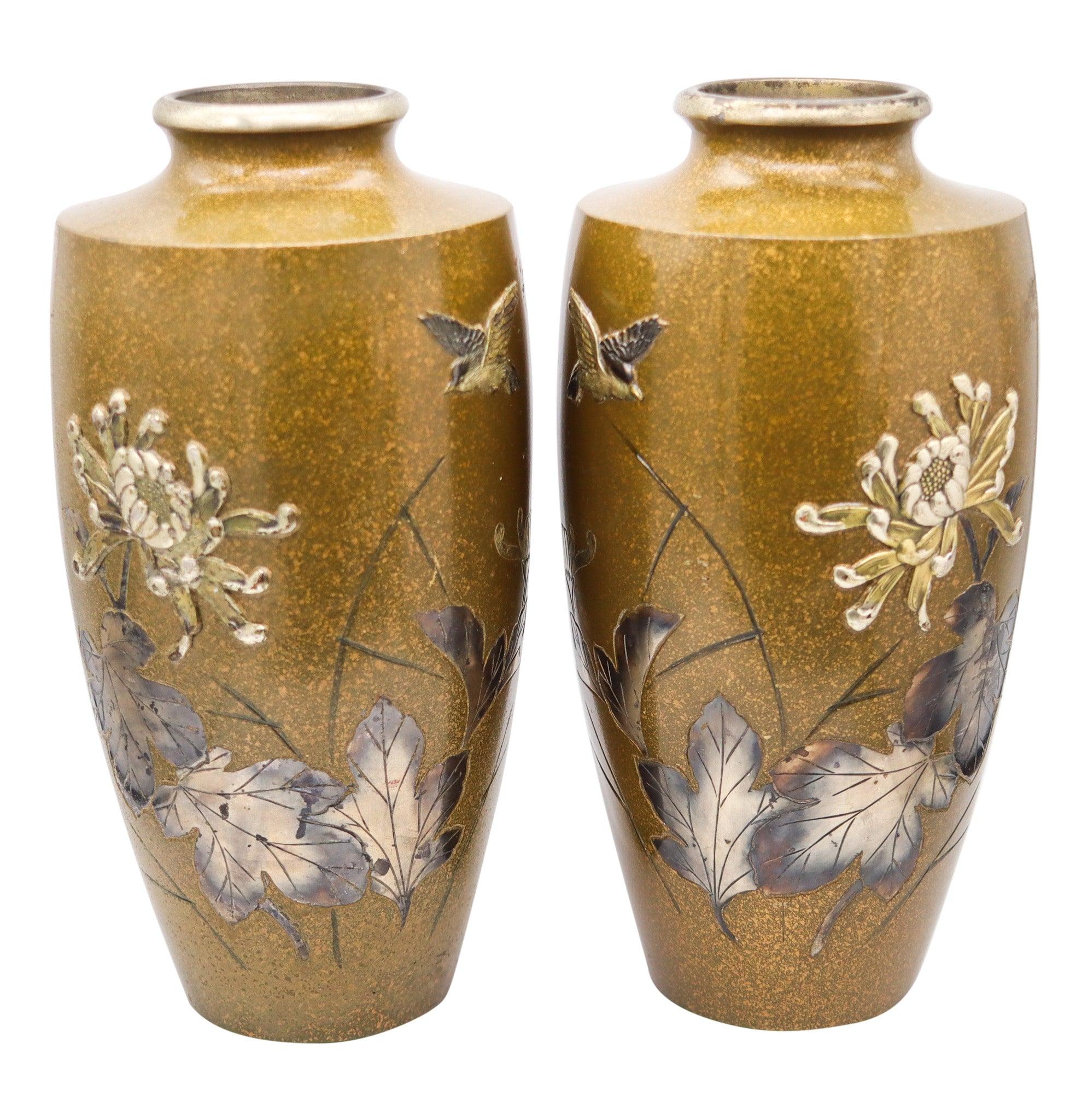 Japanese vase from the Meiji Period (1868-1912).

This is a beautiful pair of antique decorative vases created in the imperial Japan during the Meiji period (1868-1912), back in 1910. These vases have been crafted in the mixed metal technique,