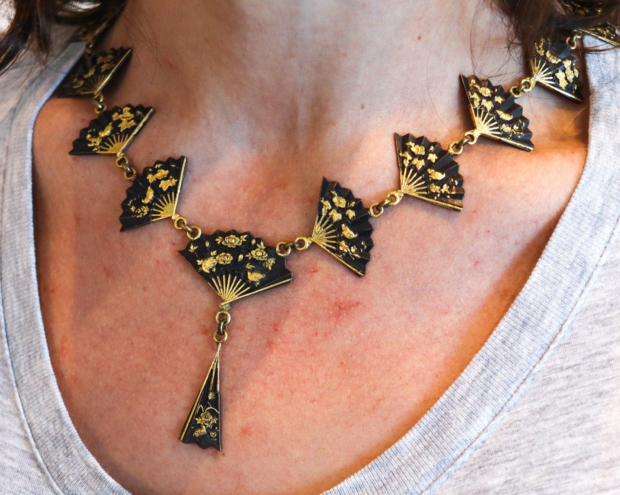 Exceptional Shakudo necklace with Japanese Menuki.

This is a fabulous one of a kind Shakudo necklace created in Japan during the Meiji period, back in 1910. The necklace has been crafted in solid yellow gold of 14 karats with brushed finish,