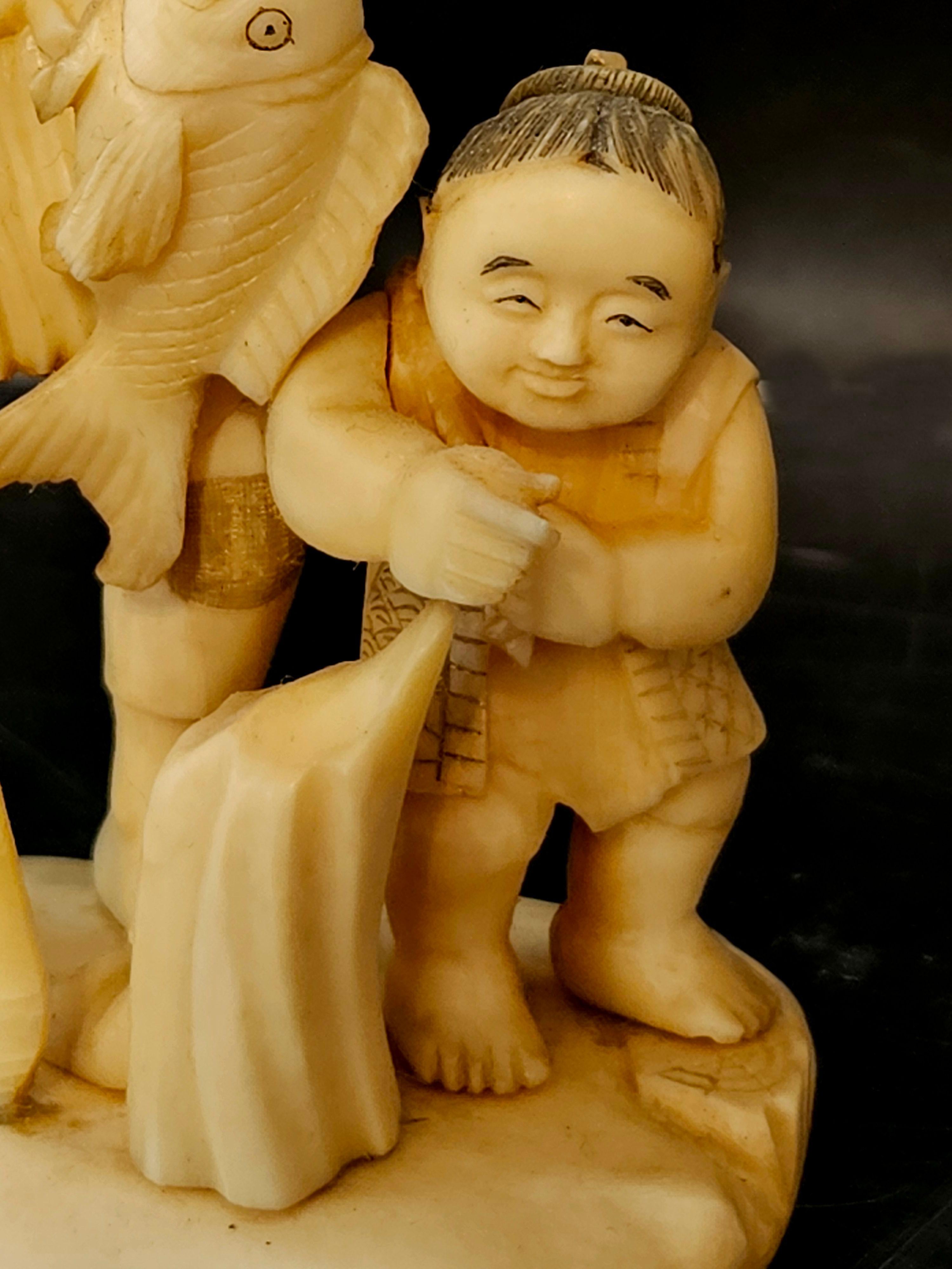 Japan Carved Okimono Group Of A Fisherman and His Kid, 1890 Meiji, Signed In Excellent Condition For Sale In Norton, MA