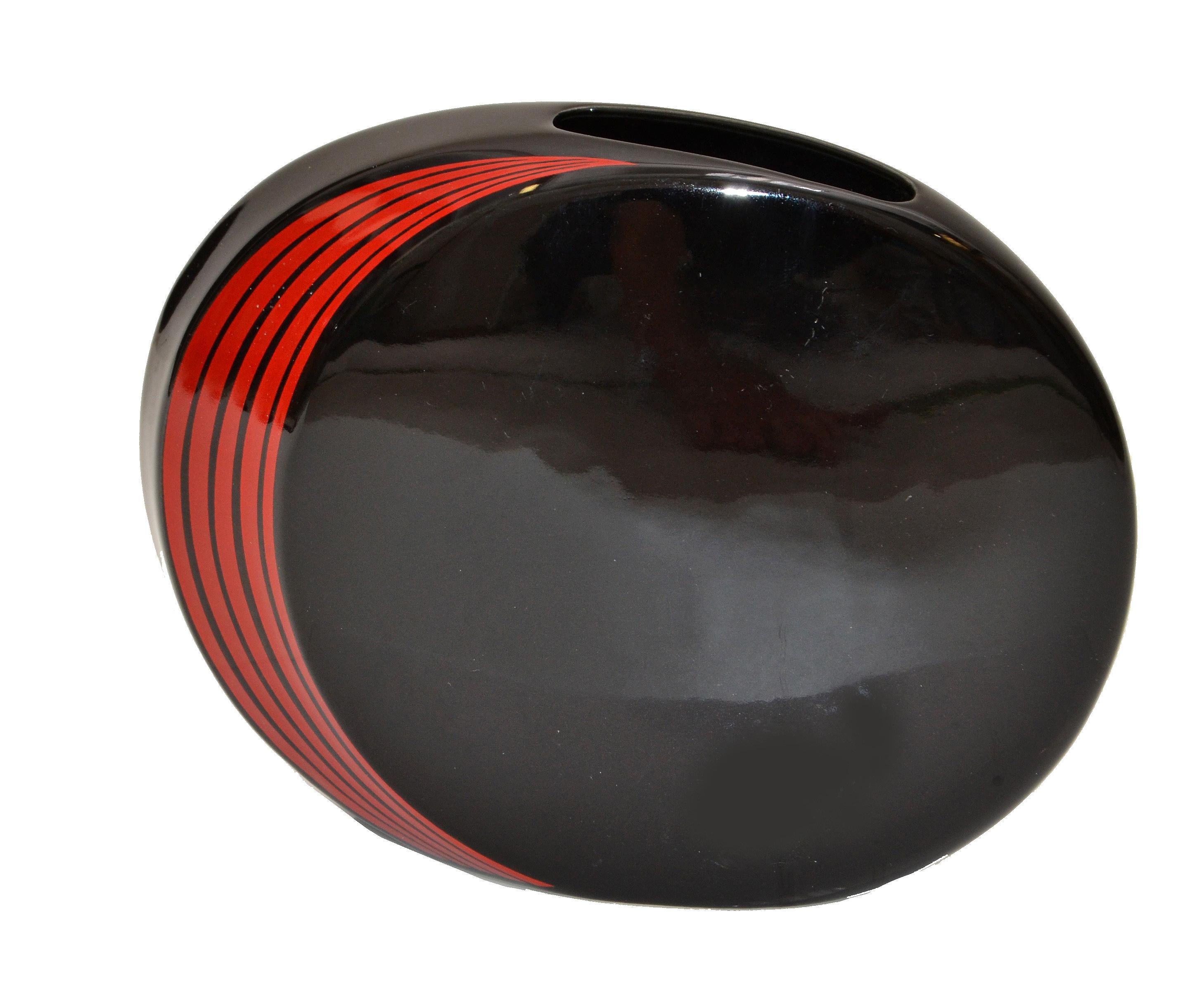 Stunning Mid-Century Modern round and flat Japan black ceramic vase with red stripes. 
Original mark at the base.
