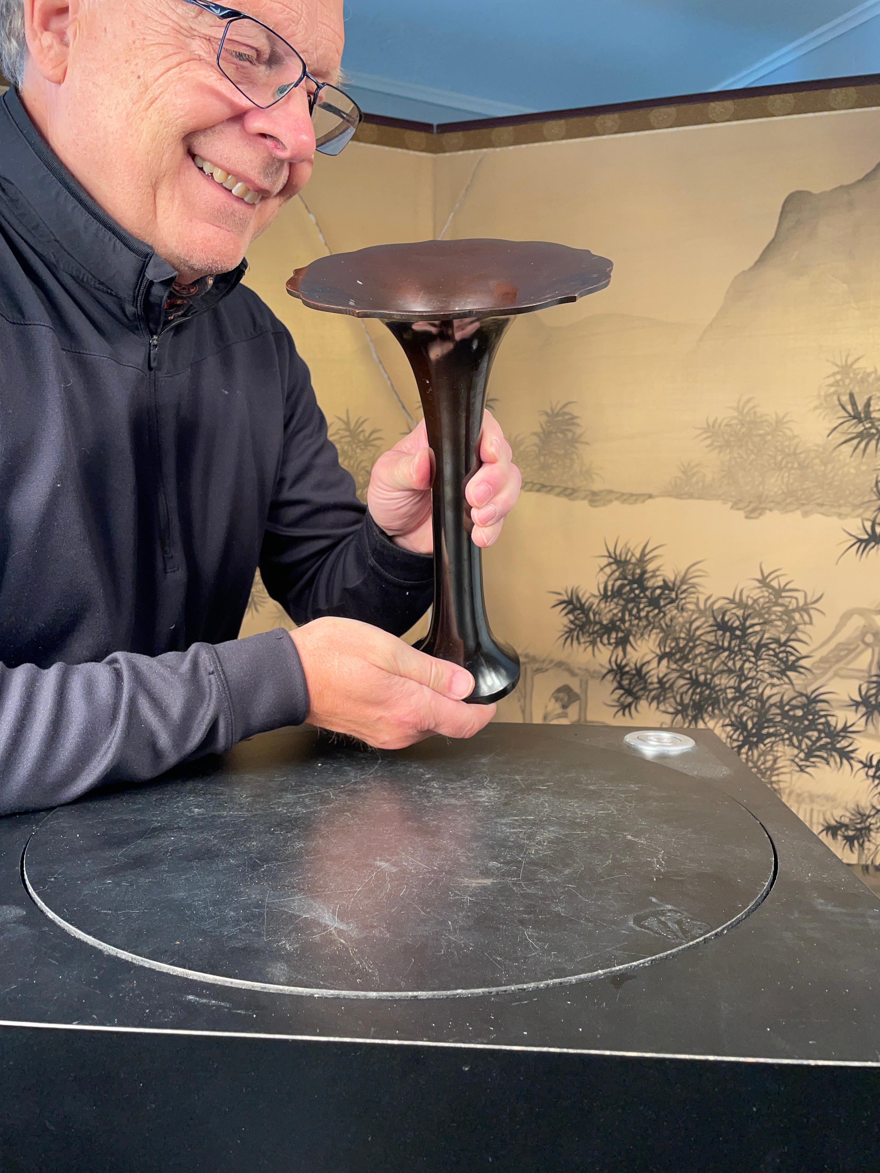 Here's another beautiful and unique way to accent your indoor space with this fine artisan treasure from Japan. 

A stunning dark walnut colored bronze vase with a pretty undulating petals shaped rim- a finished beautiful work of art from Japan.
