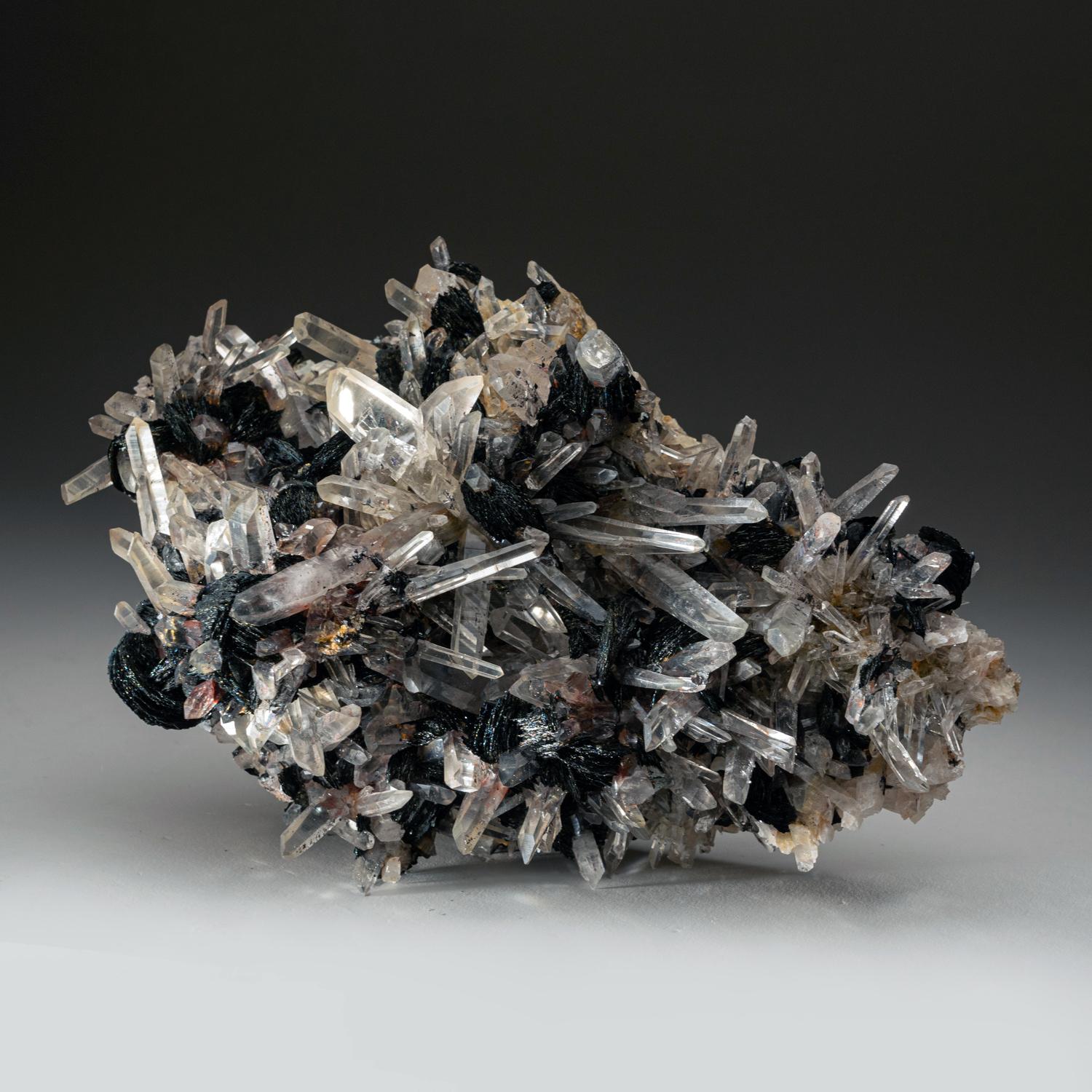 From Jinlong, northeast of Guangzhou, Longchuan, Guangdong Province, China

Large intersecting cluster of gem transparent terminated quartz crystals with bladed black-metallic hematite rosettes nestled between crystals. There's a large well