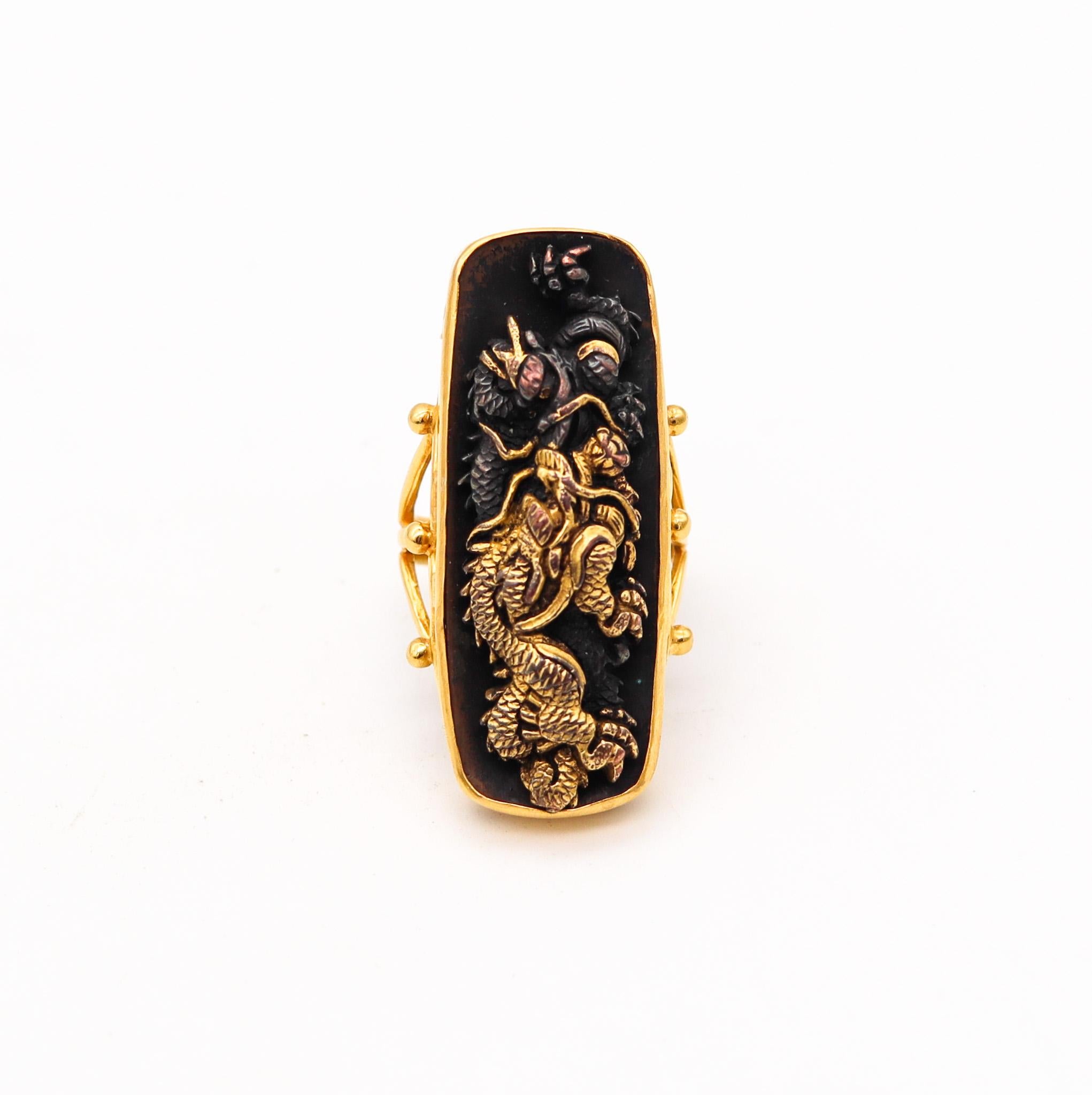 Exceptional Shakudo ring with Japanese Menuki.

Fabulous and one of a kind Shakudo cocktail ring. This ring has been crafted in solid yellow gold of 14 karats with high polished finish, chiseled 24kt gold and blackened patinated bronze (niiro). The