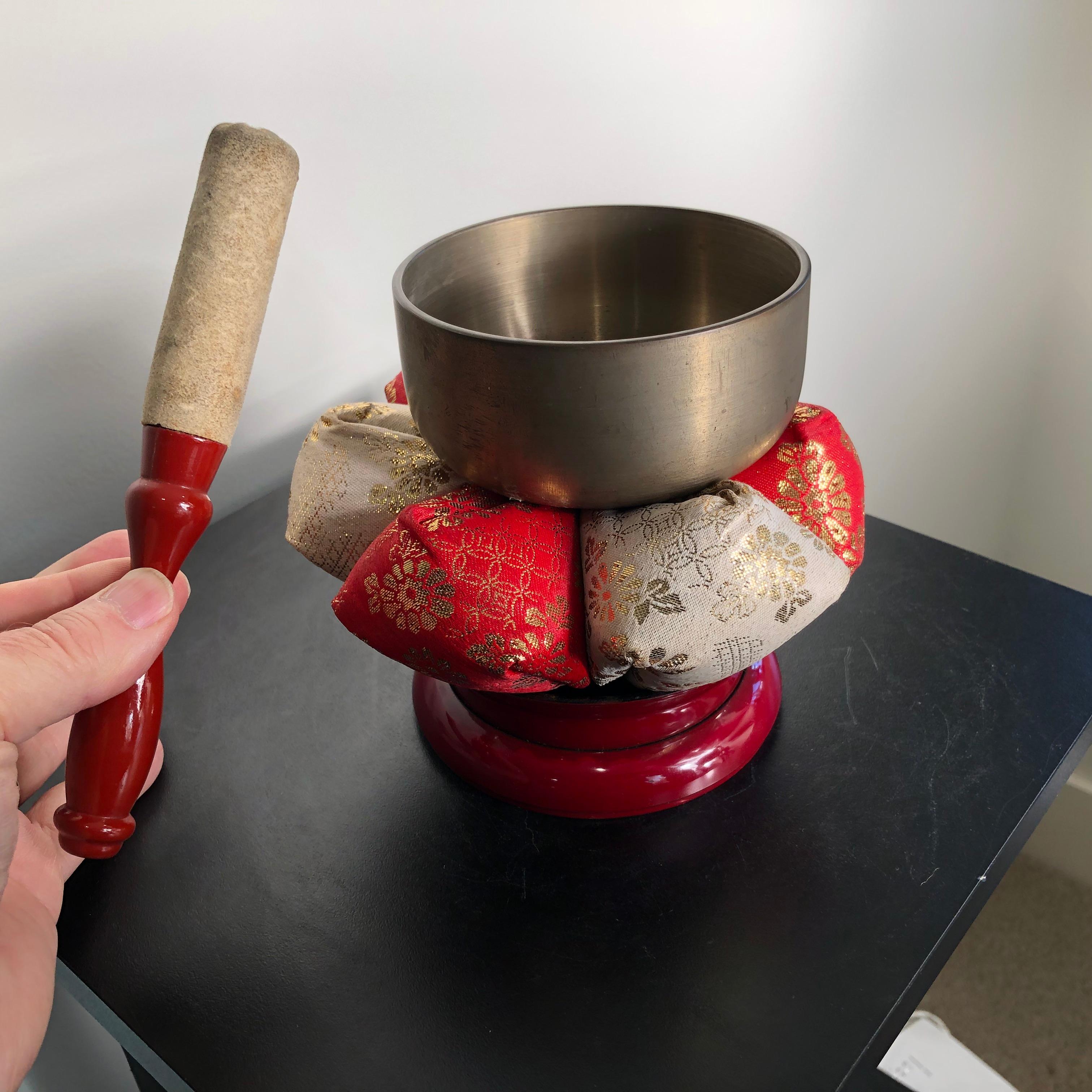 Complete with soothing sound guaranteed to please you

This is a lovely Japanese old complete bronze bell set consisting of four pieces with decorative red lacquer base and flower form pillow plus striker - a complete set.

The bell is