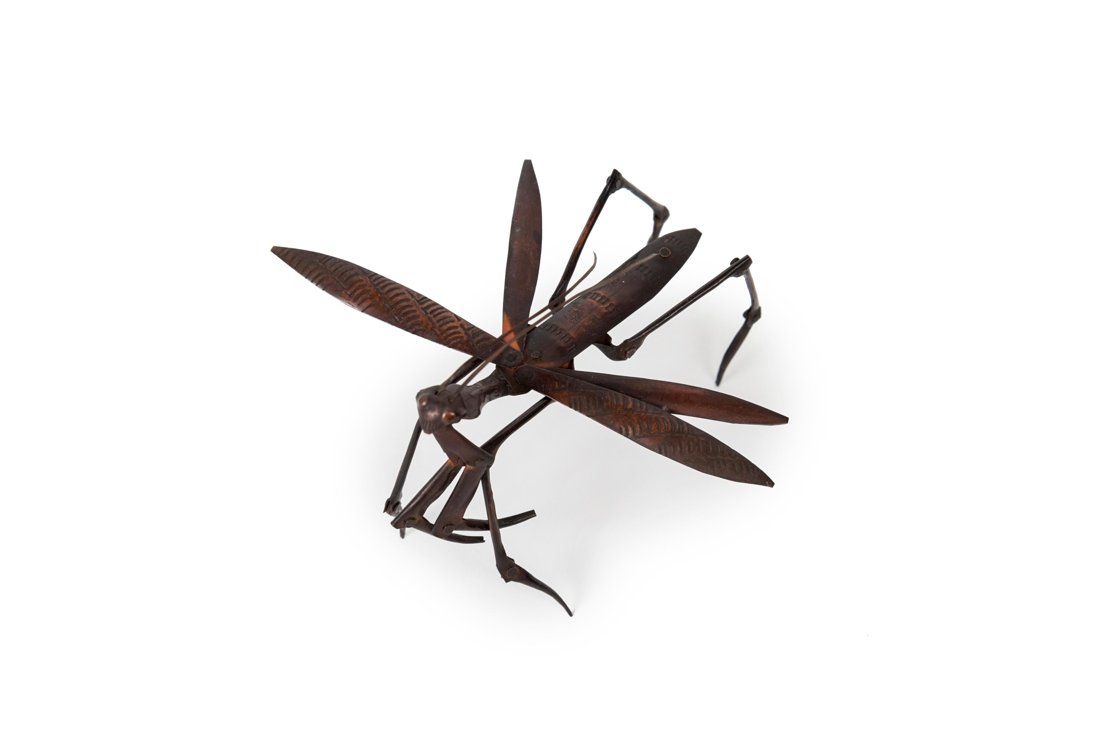 Jizai okimono of an articulated hammered copper praying mantis.

The praying mantis (in Japanese, kamakiri) is considered an auspicious symbol.

Japan – Meiji era (1868-1912)
Height: 3.15 in / 8.5 cm – width: 3.94 in / 10.5 cm – depth: 4.72 in /