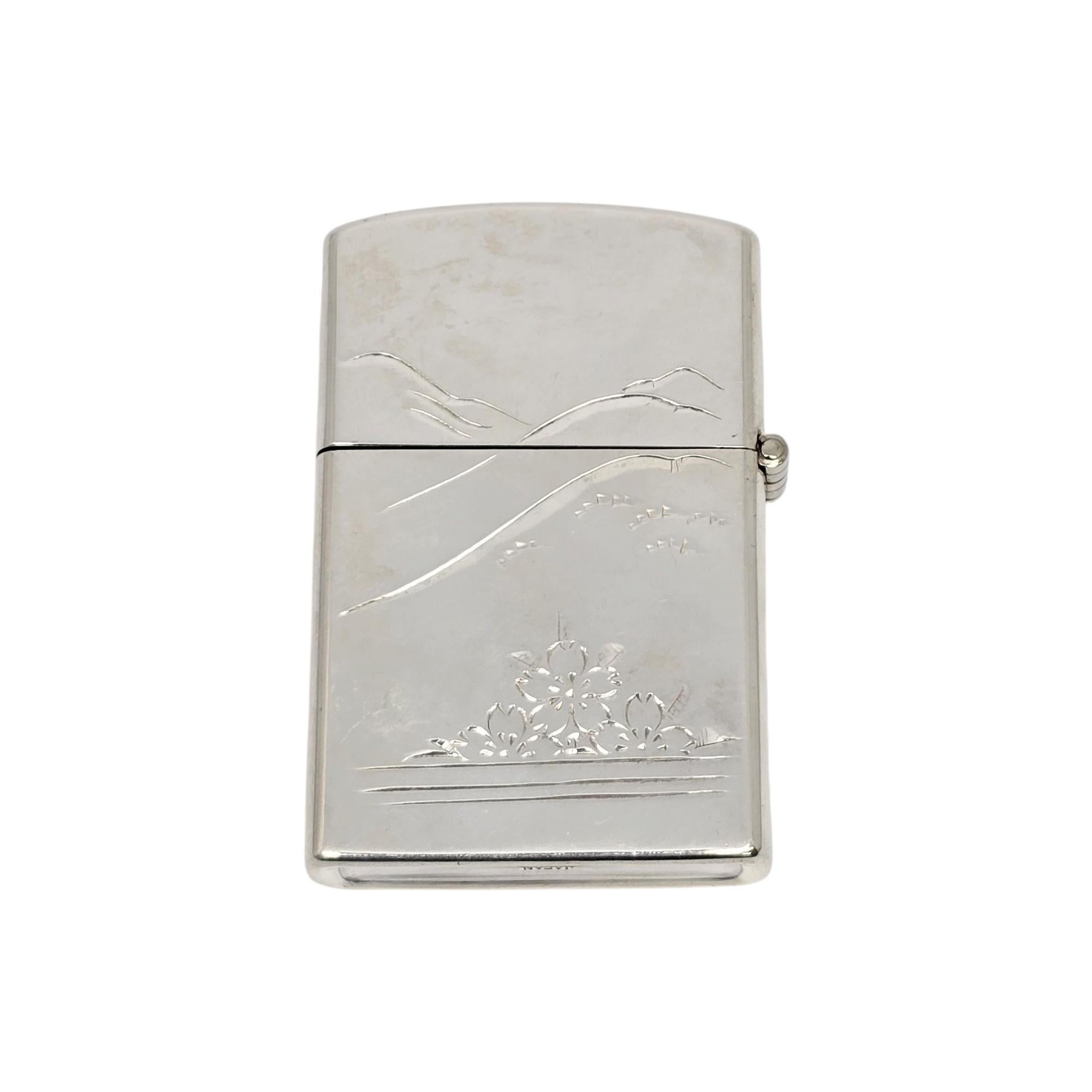 Japanese sterling silver Pagoda Mt Fuji lighter case.

A case for a lighter featuring an etched design of Mt Fuji and a pagoda on one side, mountain and flowers on the other side.

Measures approx 2 1/4